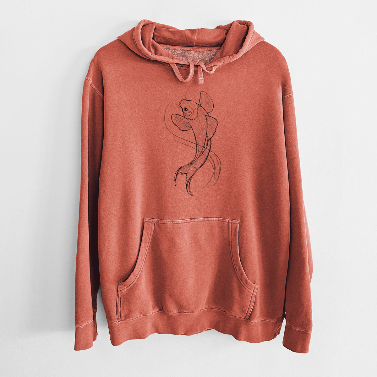 Amber orange pigment dyed hoodie laid flat, printed with a black ink line drawing of a koi fish swimming with flowing fins.