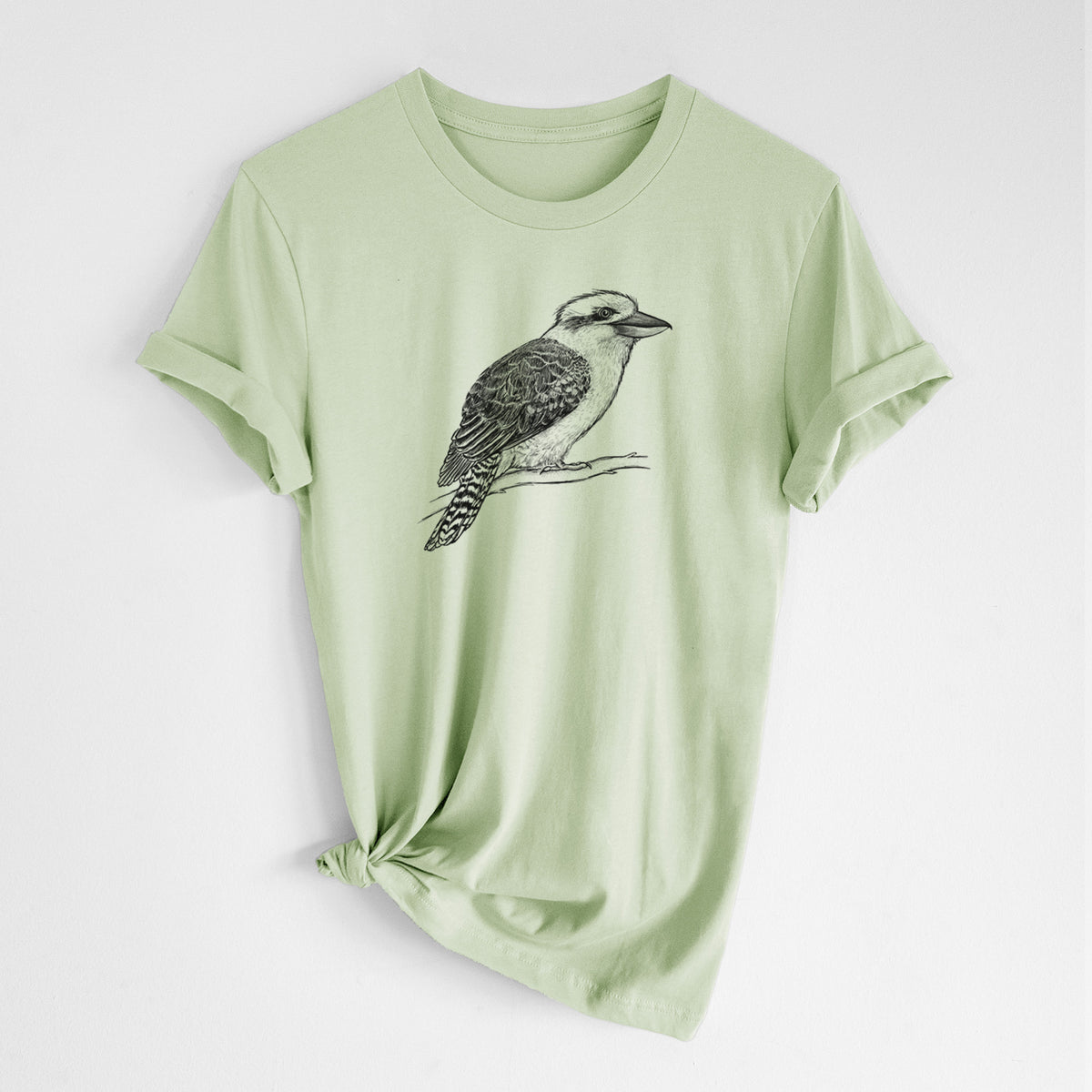 Spring green lightweight cotton t-shirt laid flat with the sleeves rolled, printed with a detailed black ink sketch of a kookaburra perched on a branch.