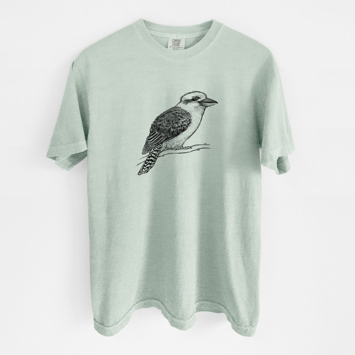 Bay green Comfort Colors t-shirt laid flat, printed with a detailed black ink sketch of a kookaburra perched on a branch.