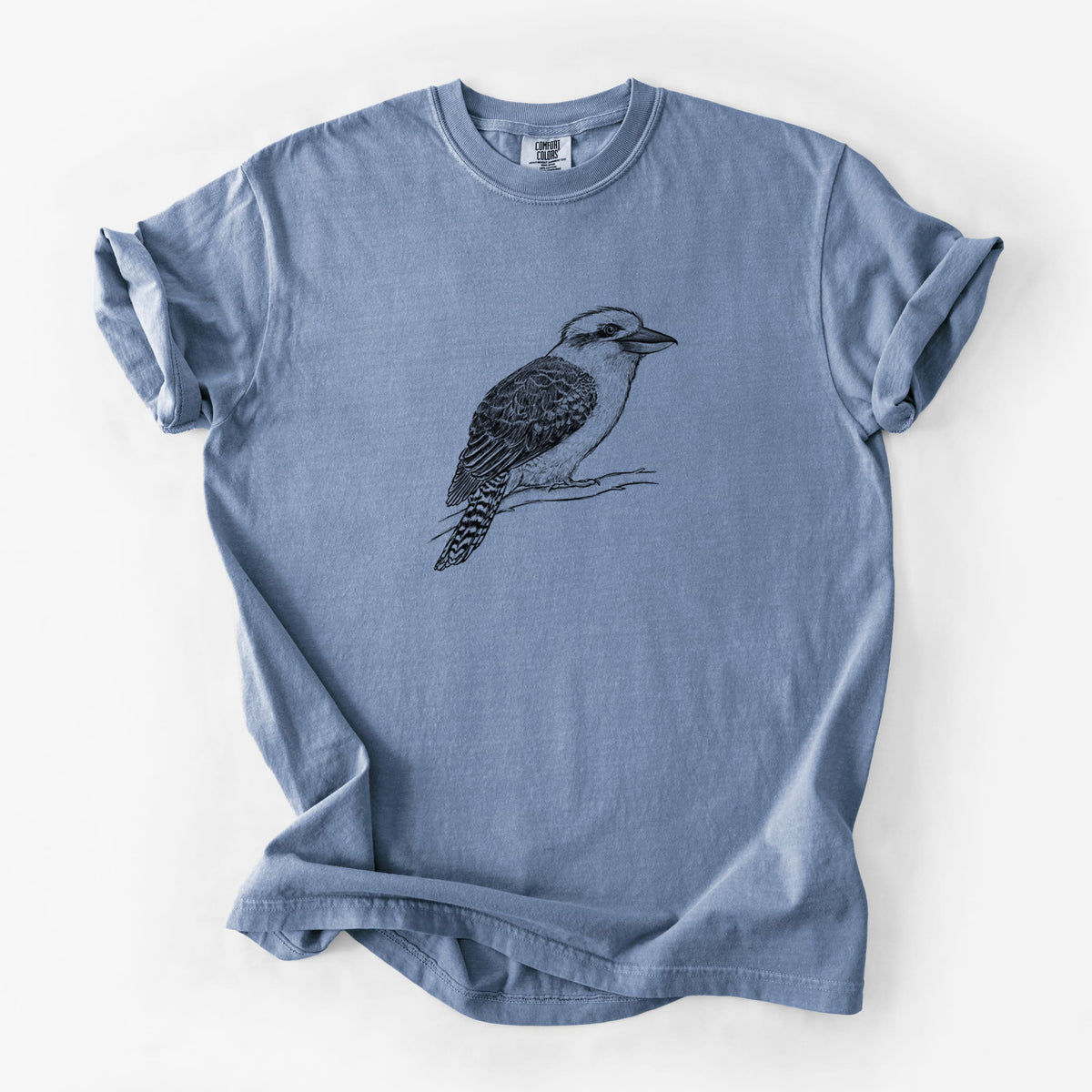 Blue jean Comfort Colors t-shirt laid flat, printed with a detailed black ink sketch of a kookaburra perched on a branch.