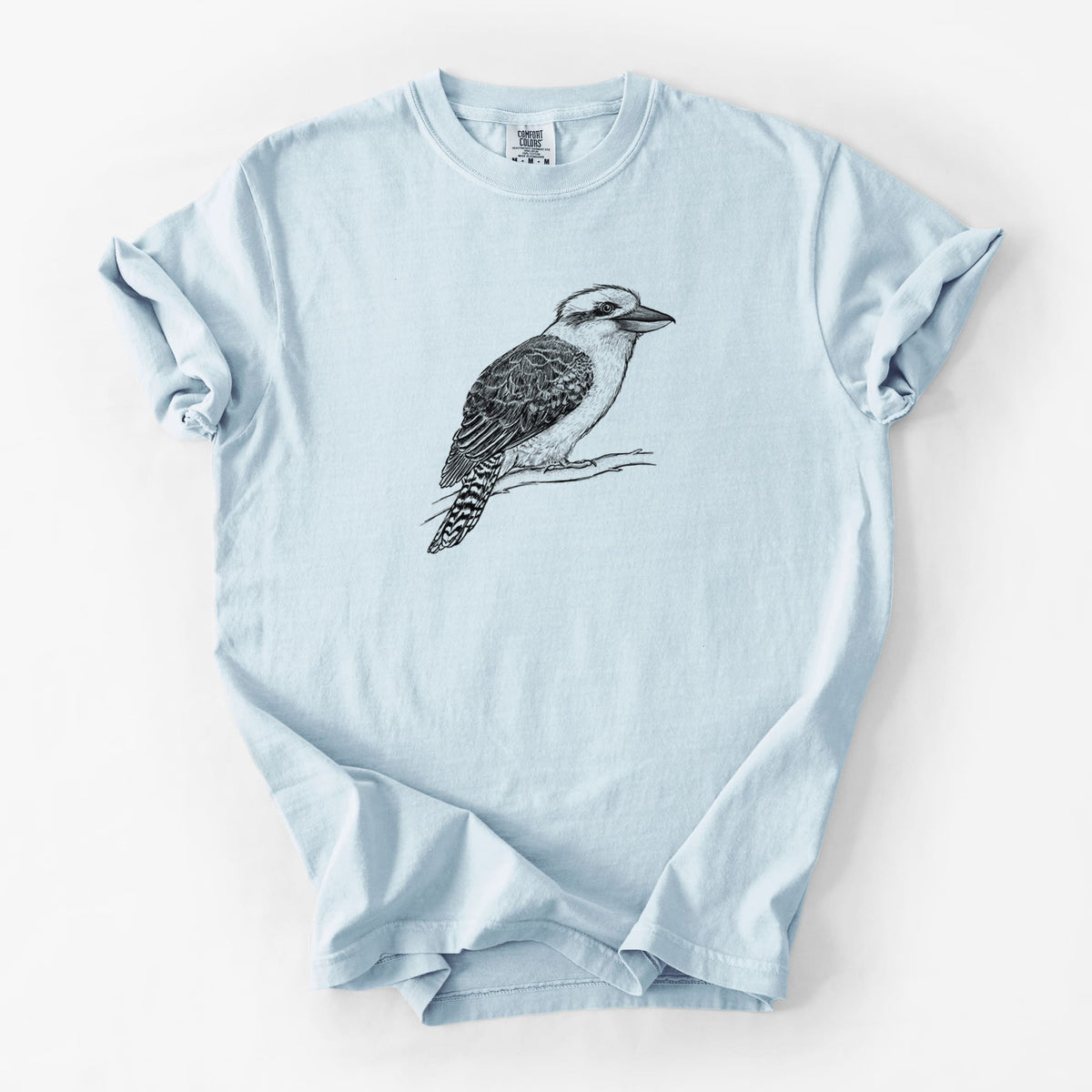 Chambray blue Comfort Colors t-shirt laid flat, printed with a detailed black ink sketch of a kookaburra perched on a branch.
