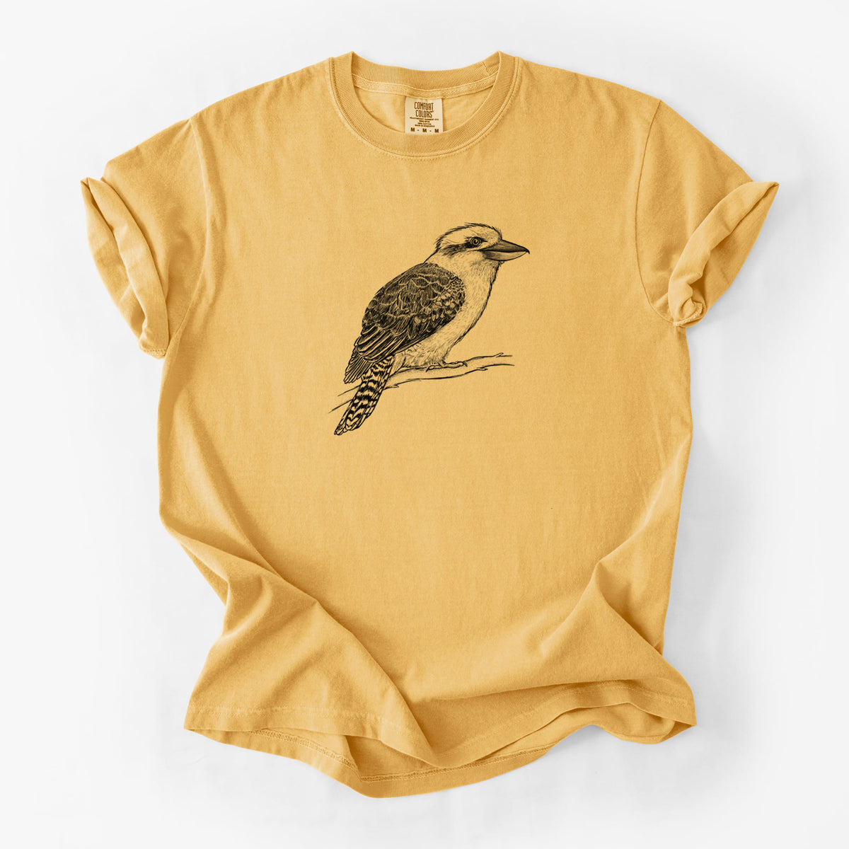 Golden wheat yellow Comfort Colors t-shirt laid flat, printed with a detailed black ink sketch of a kookaburra perched on a branch.