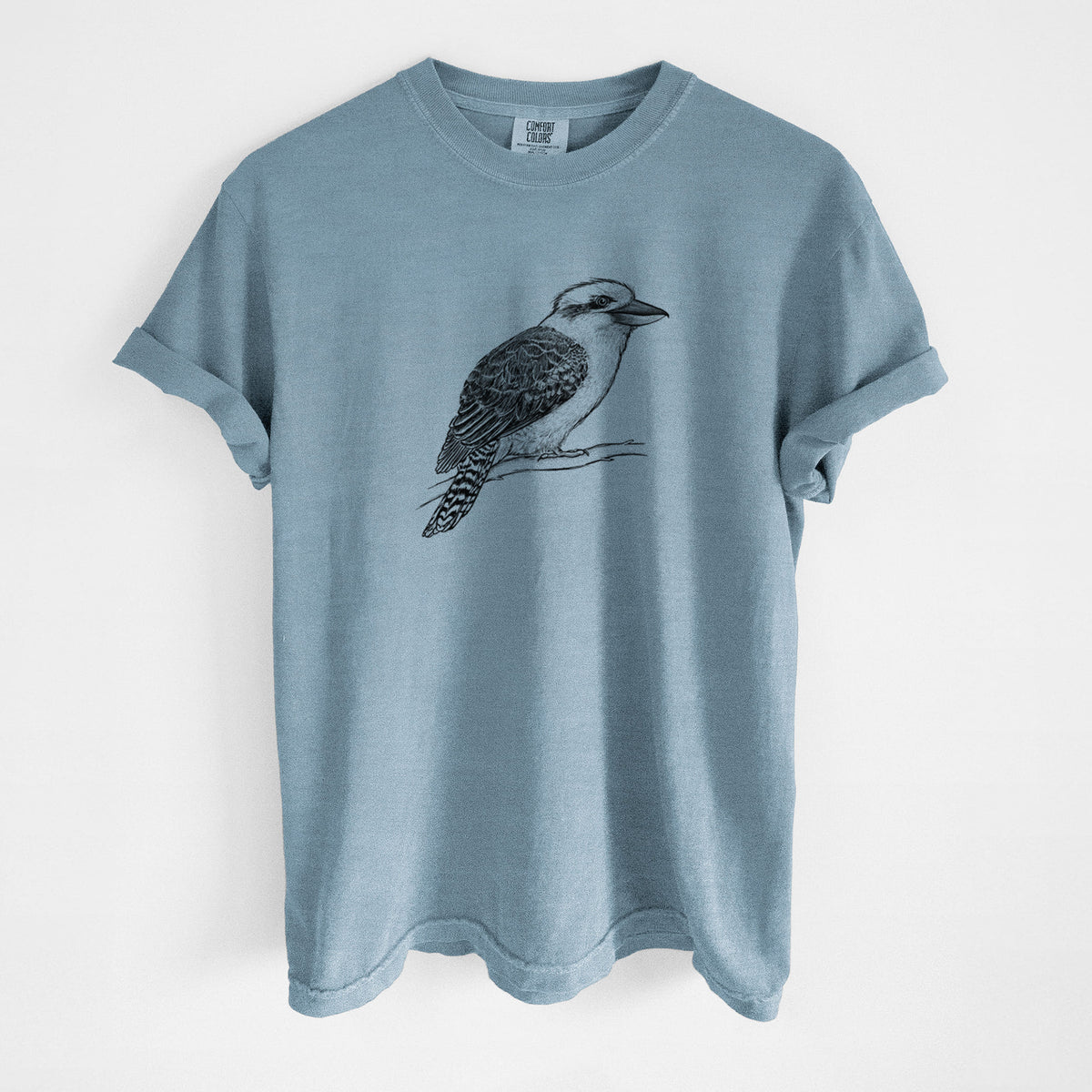 Steel blue Comfort Colors t-shirt laid flat, printed with a detailed black ink sketch of a kookaburra perched on a branch.