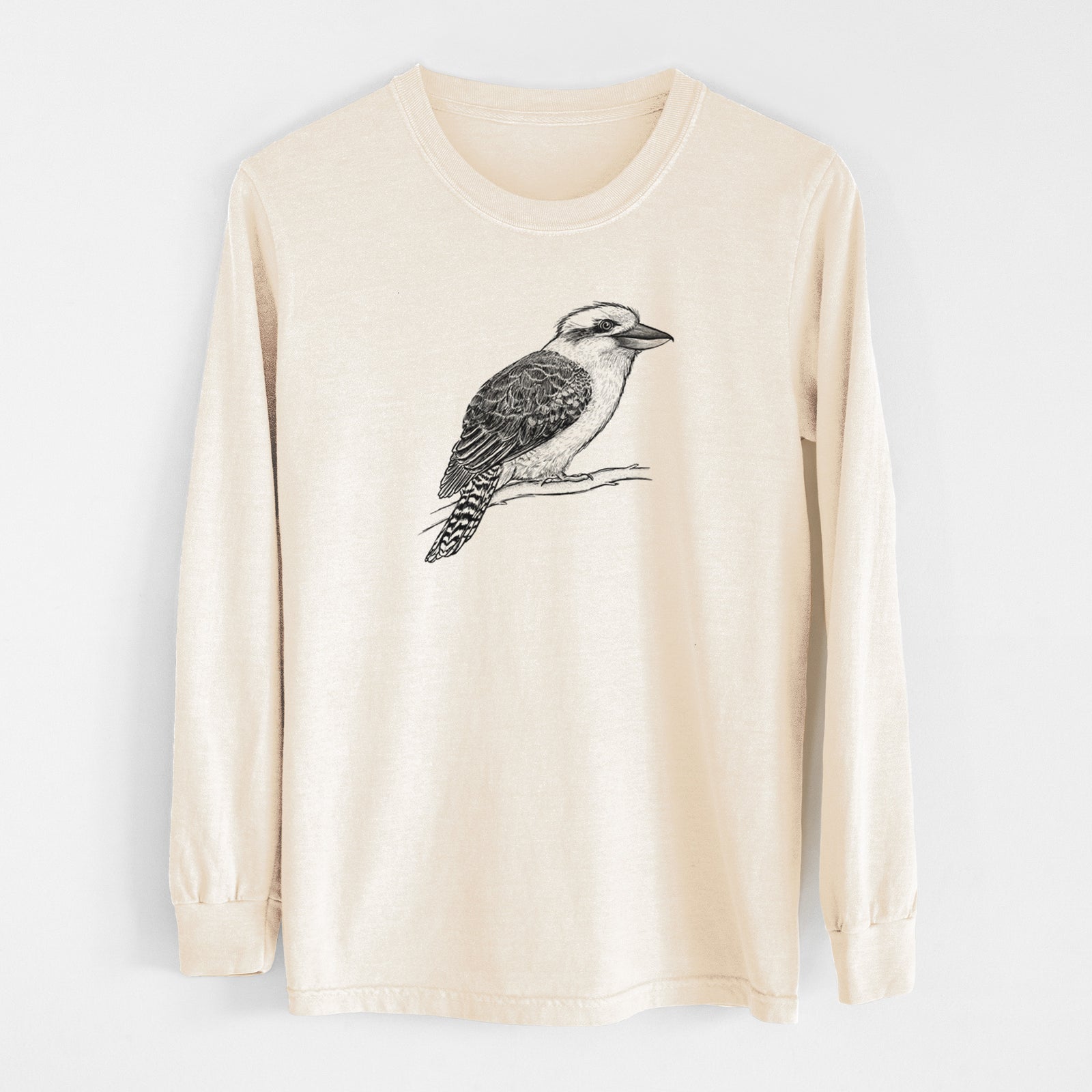 Ivory Comfort Colors long sleeve shirt laid flat, printed with a detailed black ink sketch of a kookaburra perched on a branch.