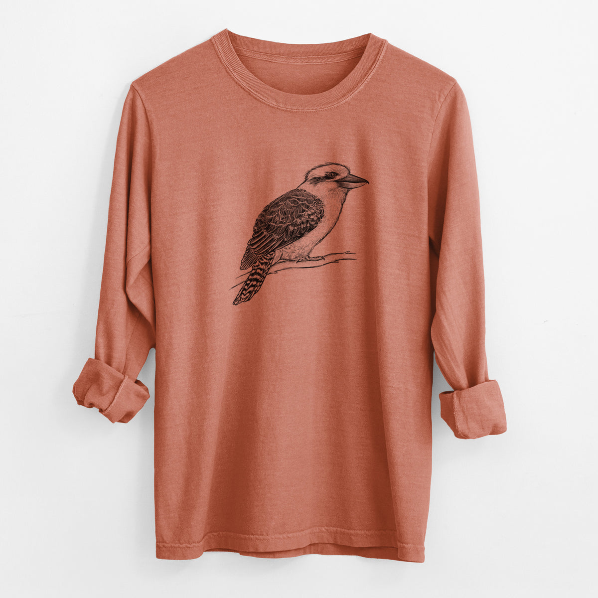 Yam burnt orange Comfort Colors long sleeve shirt laid flat with the cuffs rolled, printed with a detailed black ink sketch of a kookaburra perched on a branch.