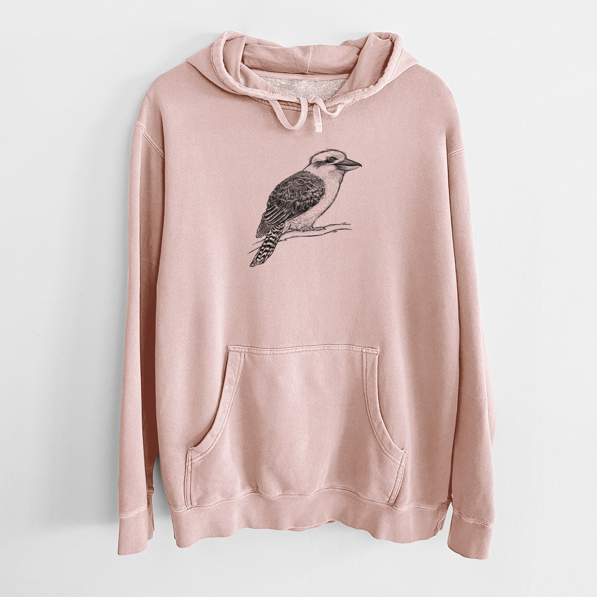Dusty pink pigment dyed hoodie laid flat, printed with a detailed black ink sketch of a kookaburra perched on a branch.