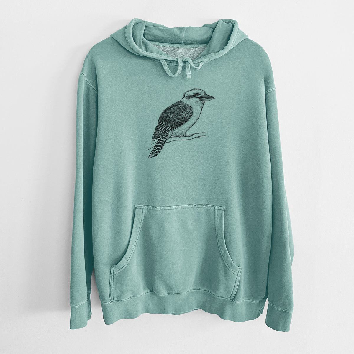 Mint green pigment dyed hoodie laid flat, printed with a detailed black ink sketch of a kookaburra perched on a branch.