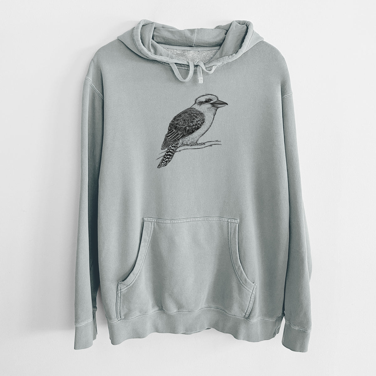 Sage green pigment dyed hoodie laid flat, printed with a detailed black ink sketch of a kookaburra perched on a branch.