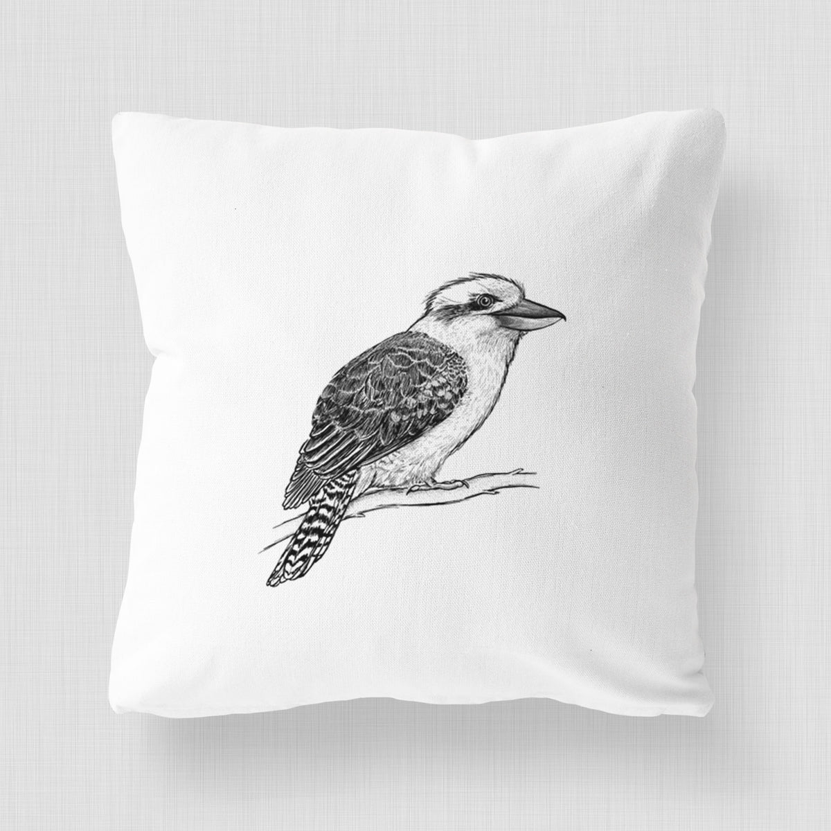 White pillow cover printed with a detailed black ink sketch of a kookaburra perched on a branch.