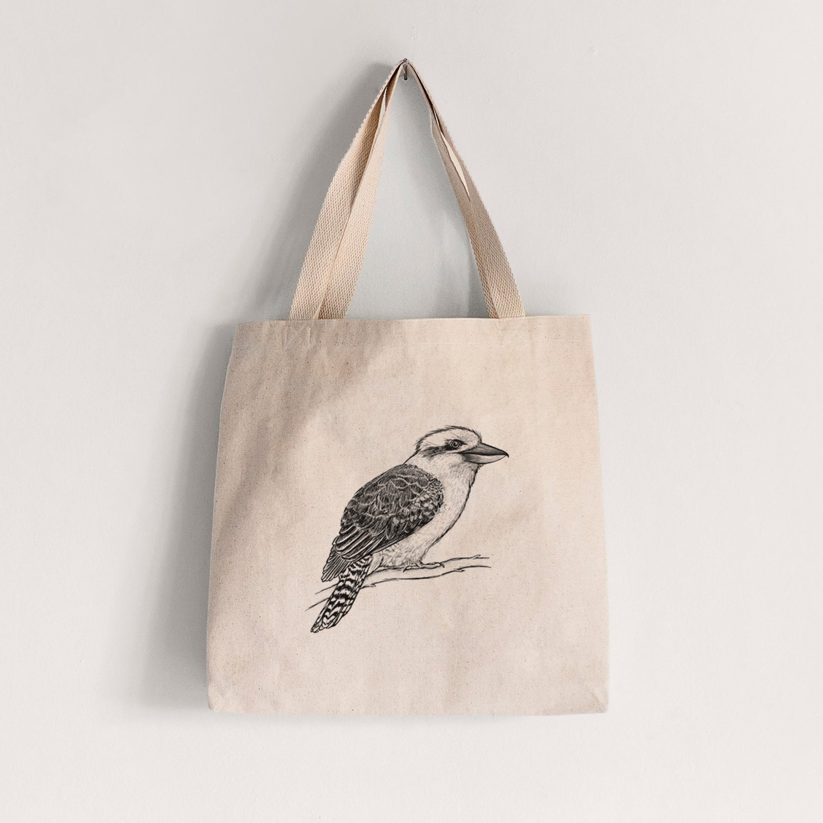 Natural canvas tote bag printed with a detailed black ink sketch of a kookaburra perched on a branch.
