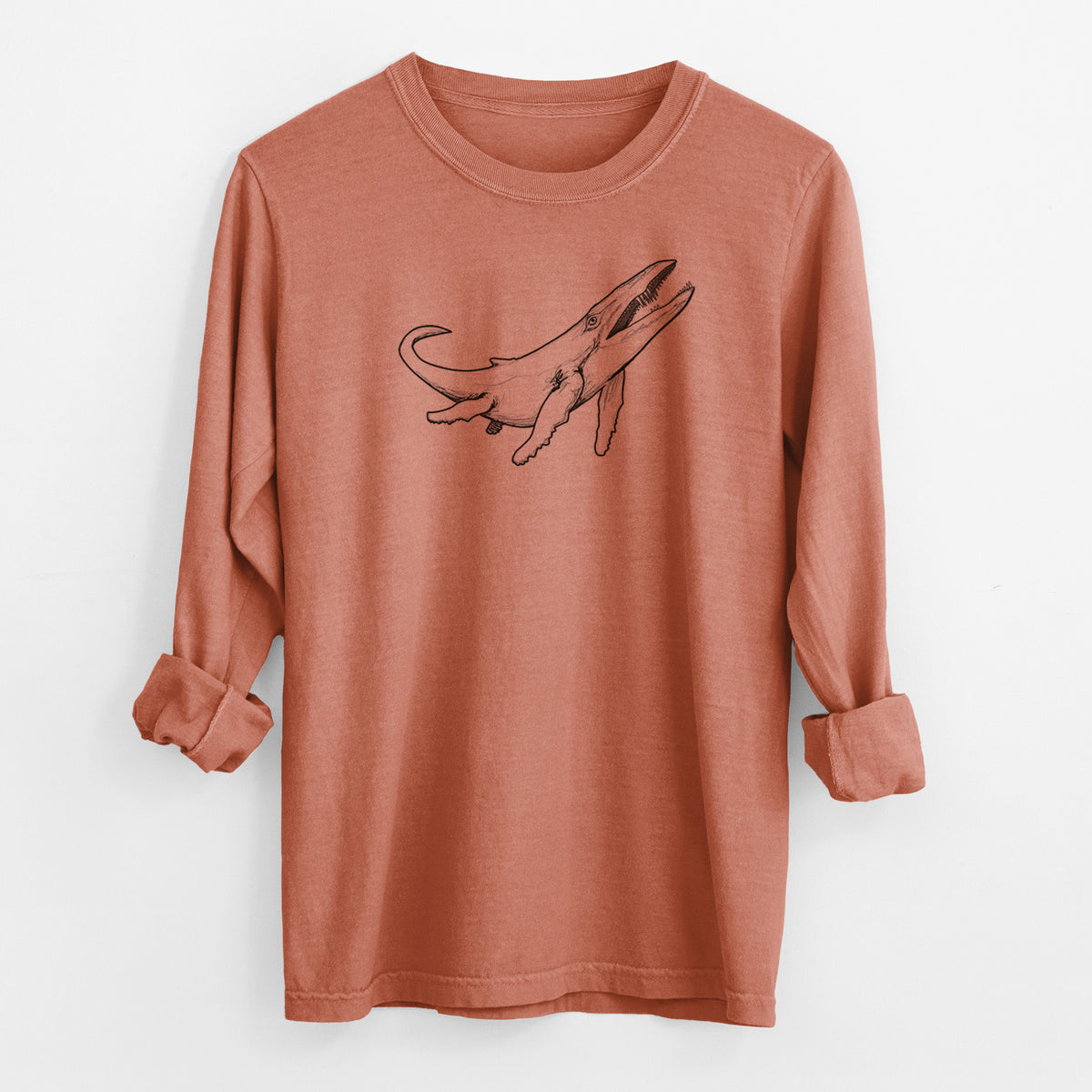 Yam burnt orange Comfort Colors long sleeve shirt laid flat with the cuffs rolled, printed with a black ink illustration of a Kronosaurus marine reptile swimming.