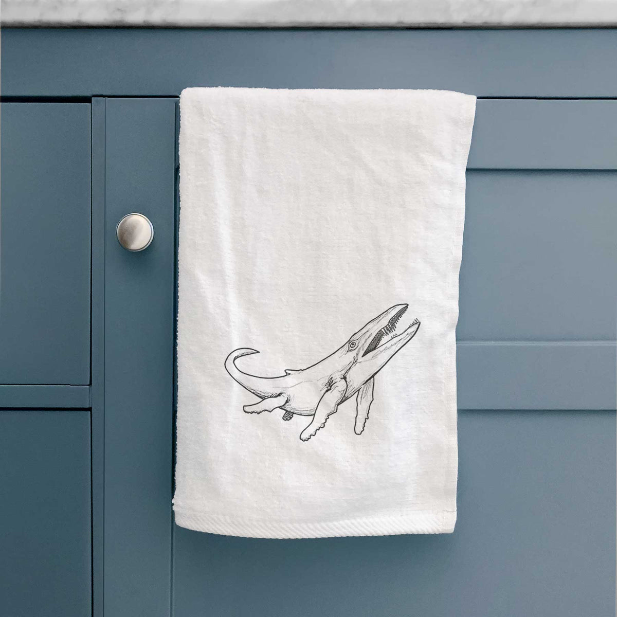 White hand towel printed with a black ink illustration of a Kronosaurus marine reptile swimming.