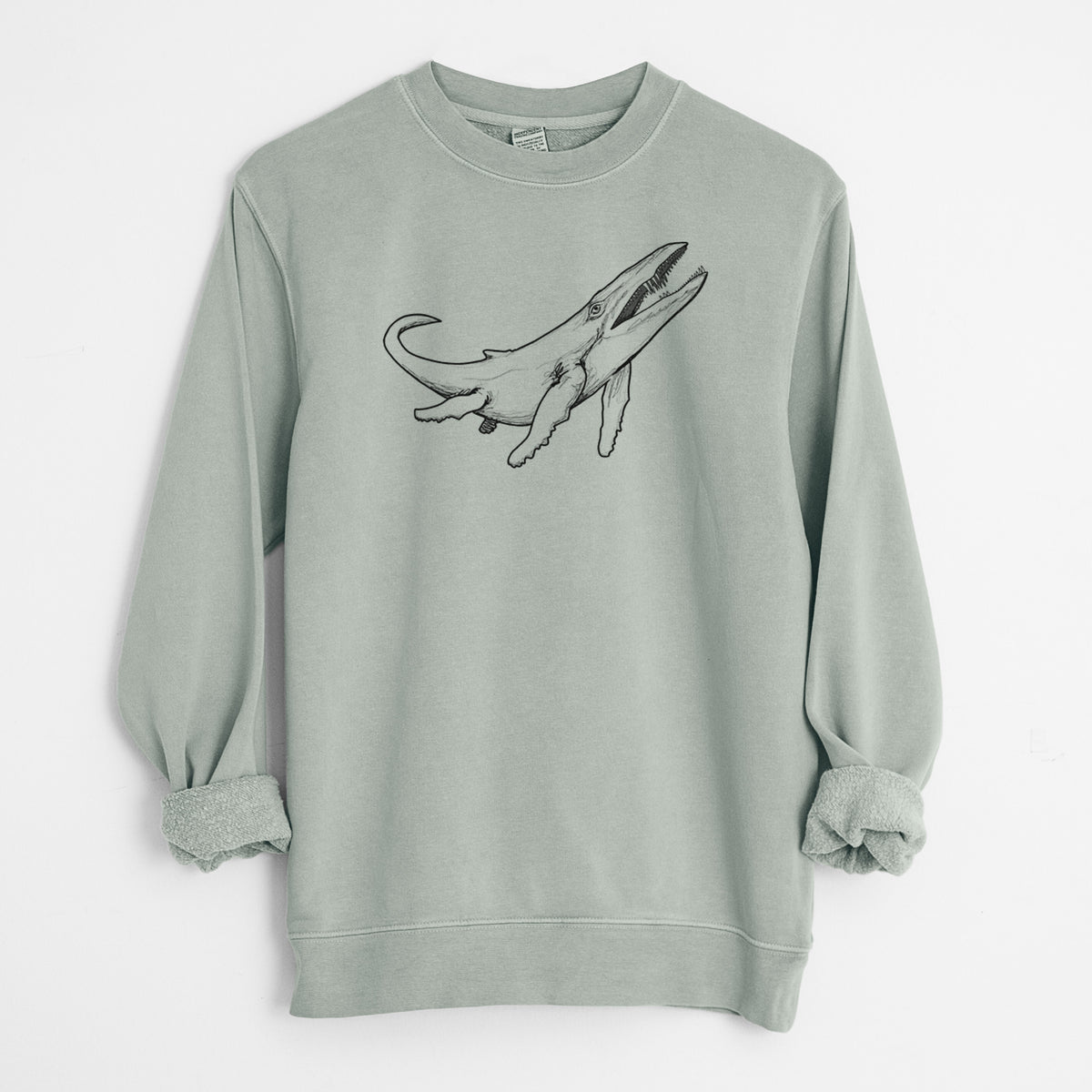 Sage green pigment dyed crewneck sweatshirt laid flat with the sleeves rolled, printed with a black ink illustration of a Kronosaurus marine reptile swimming.