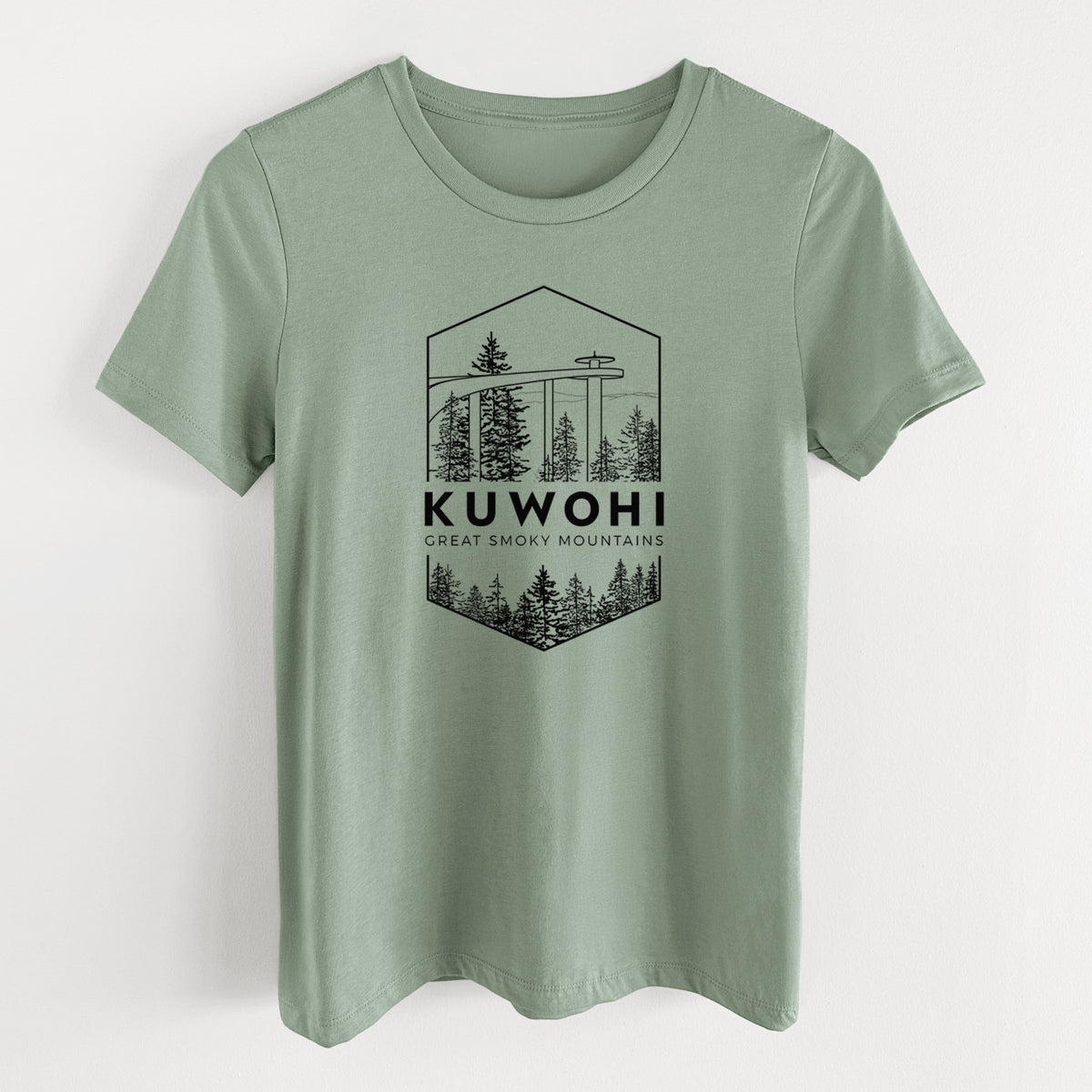 Sage green women's relaxed fit cotton t-shirt laid flat, printed with a black line art badge of the Kuwohi observation tower above pine trees, with the words Kuwohi, Great Smoky Mountains.