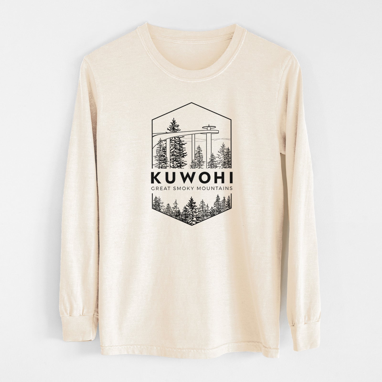 Ivory Comfort Colors long sleeve shirt laid flat, printed with a black line art badge of the Kuwohi observation tower above pine trees, with the words Kuwohi, Great Smoky Mountains.
