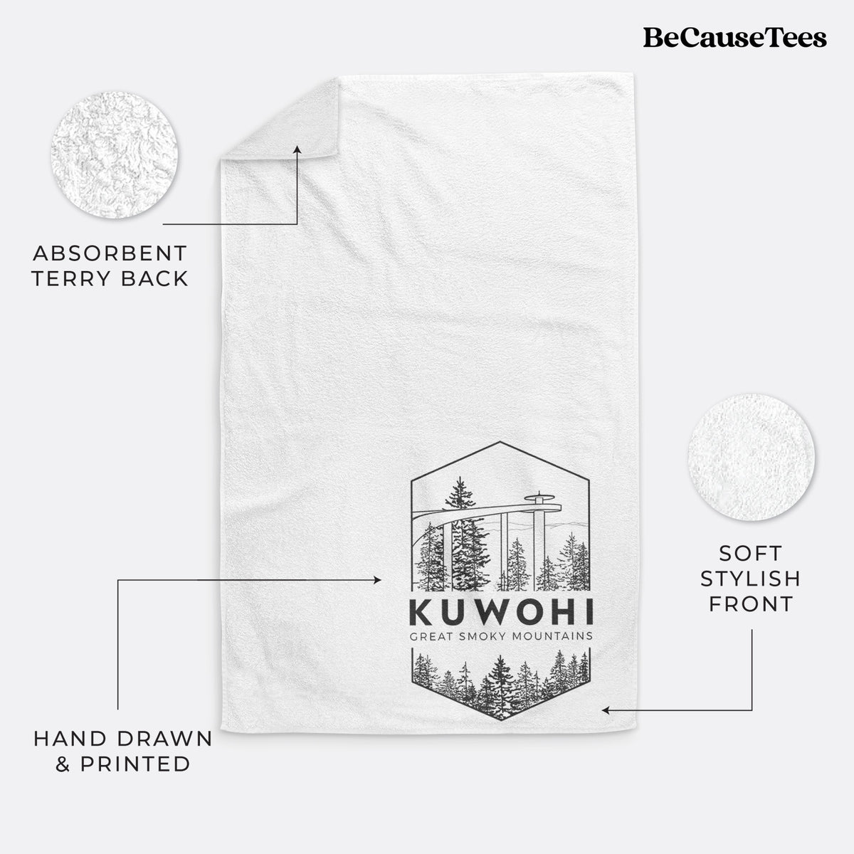 White hand towel printed with a black line art badge of the Kuwohi observation tower above pine trees, with the words Kuwohi, Great Smoky Mountains.