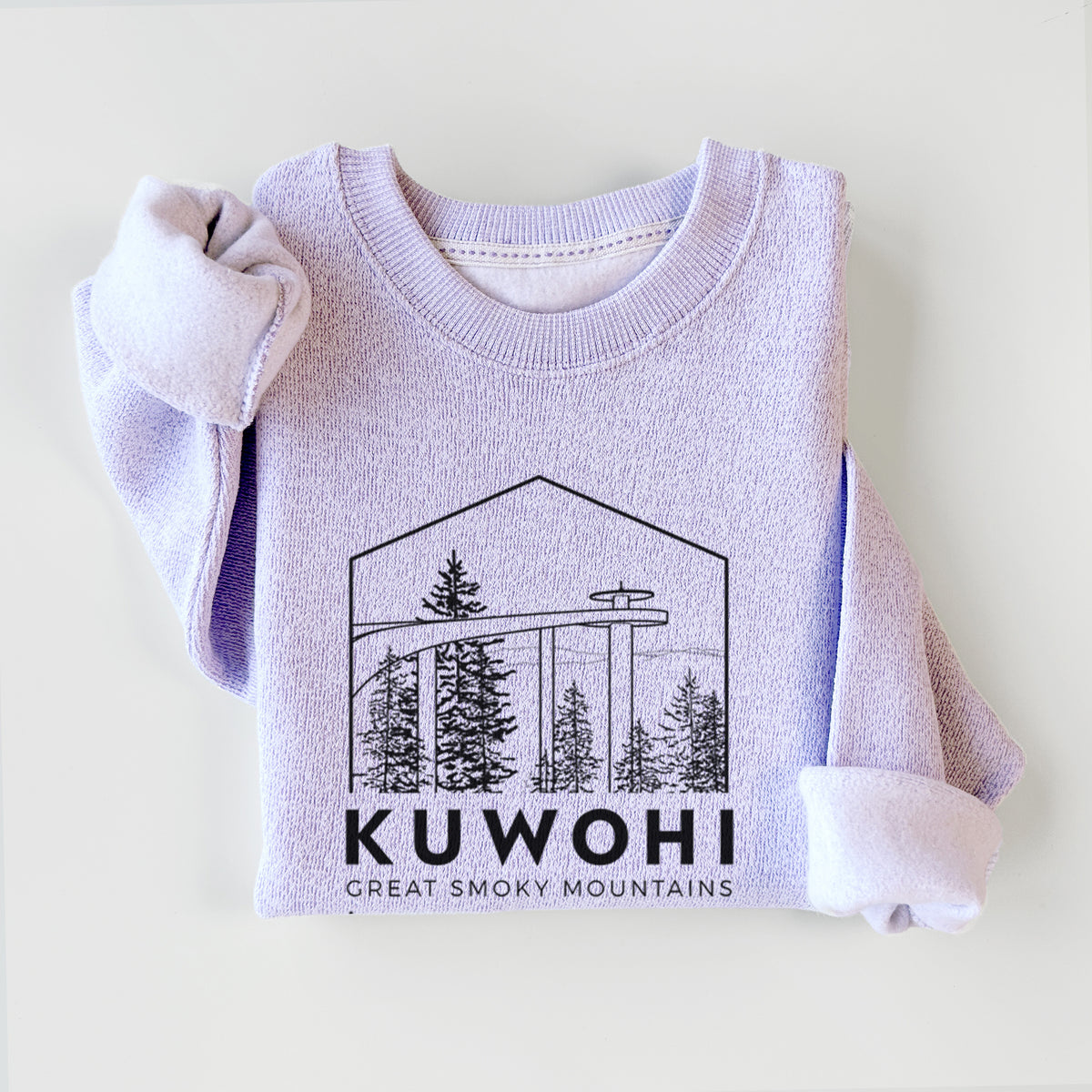Ice purple knit sweatshirt printed with a black line art badge of the Kuwohi observation tower above pine trees, with the words Kuwohi, Great Smoky Mountains, styled flat.