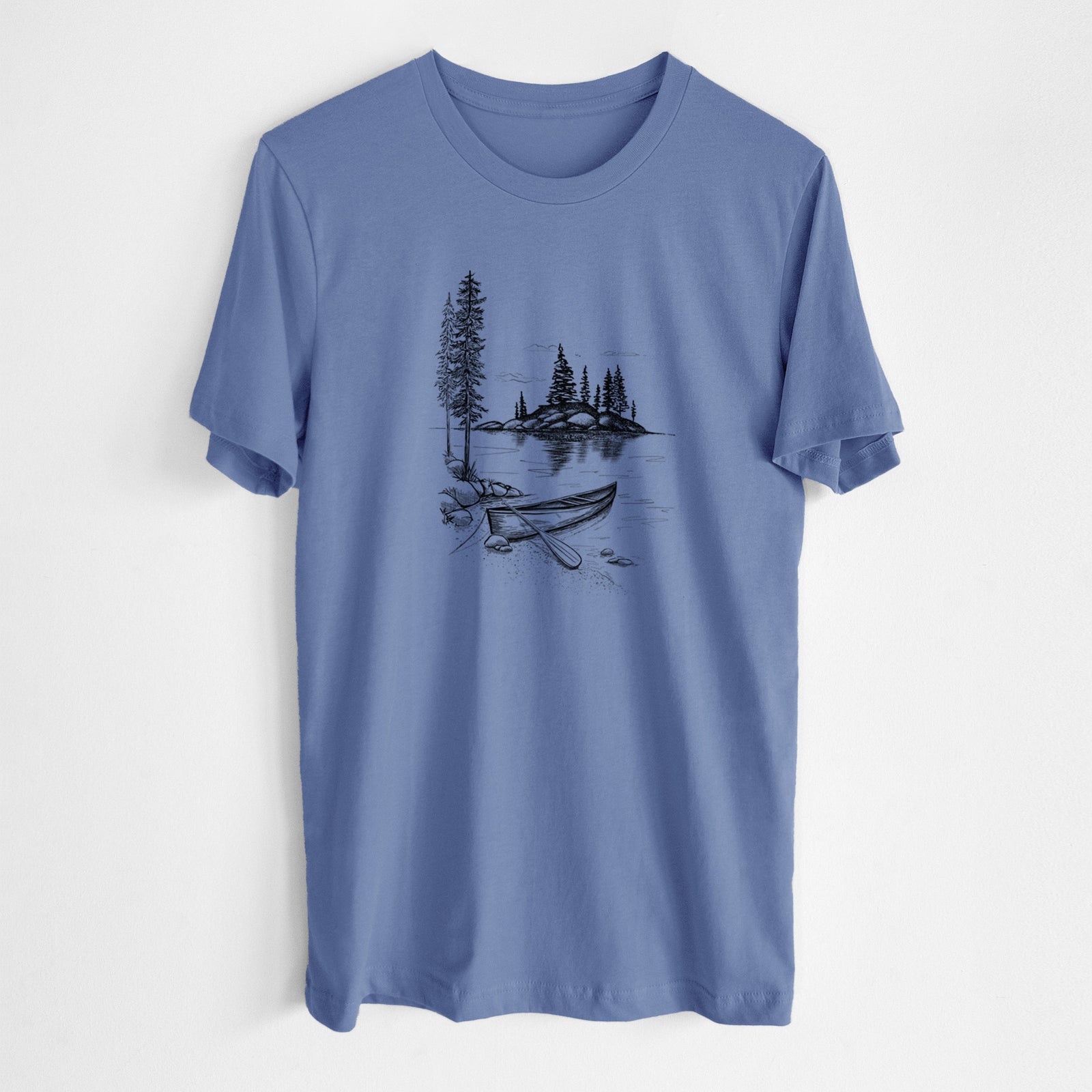 Blue bell lightweight cotton t-shirt laid flat, printed with a black ink illustration of a canoe resting on the shore of a lake with pine trees on a small island.