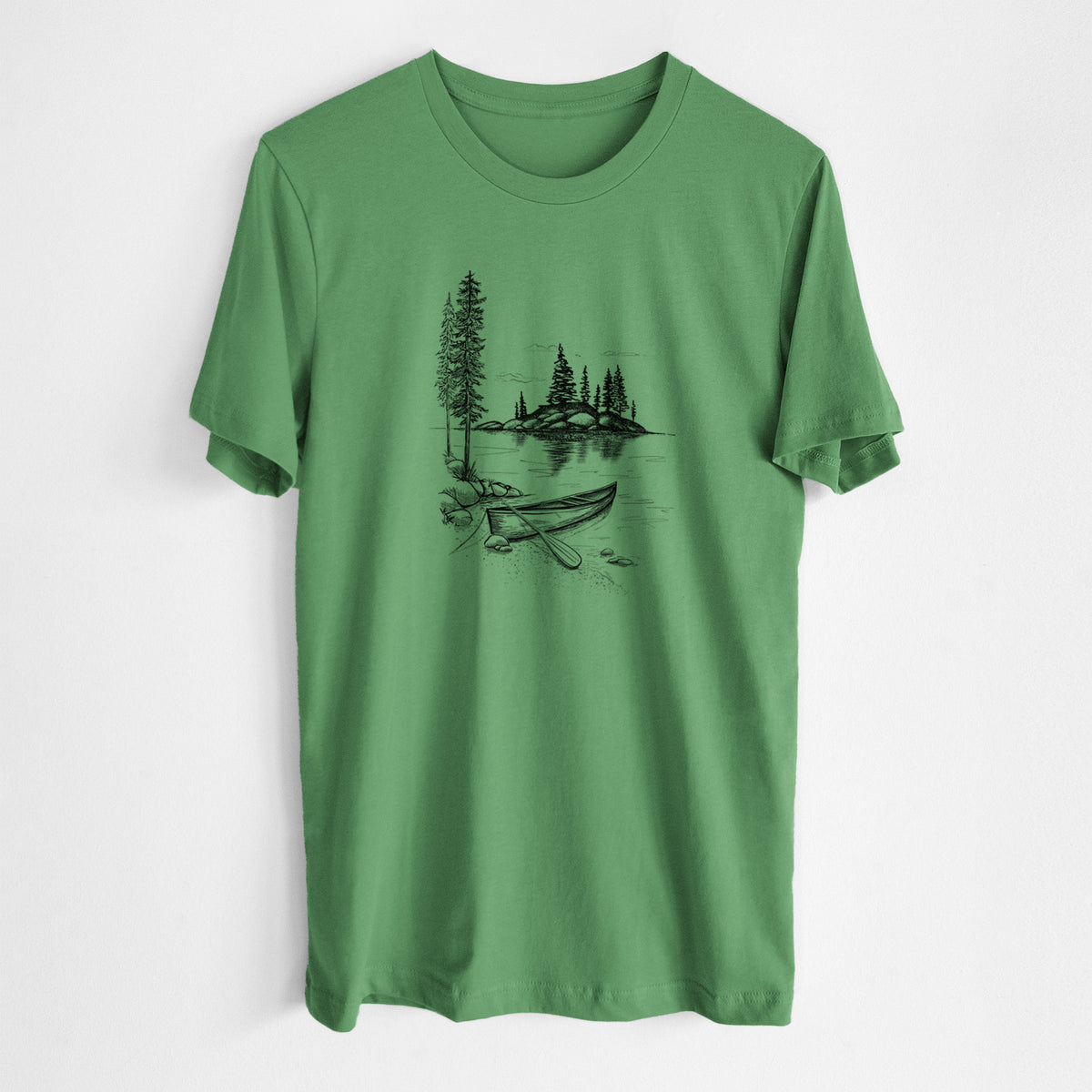 Leaf green lightweight cotton t-shirt laid flat, printed with a black ink illustration of a canoe resting on the shore of a lake with pine trees on a small island.