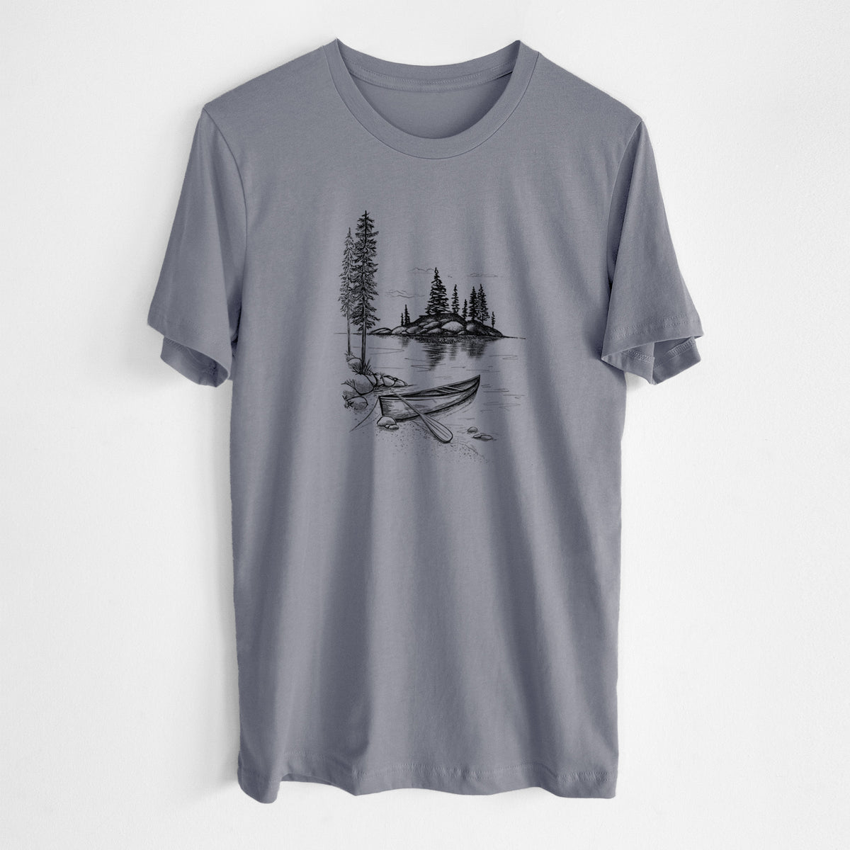 Storm grey lightweight cotton t-shirt laid flat, printed with a black ink illustration of a canoe resting on the shore of a lake with pine trees on a small island.