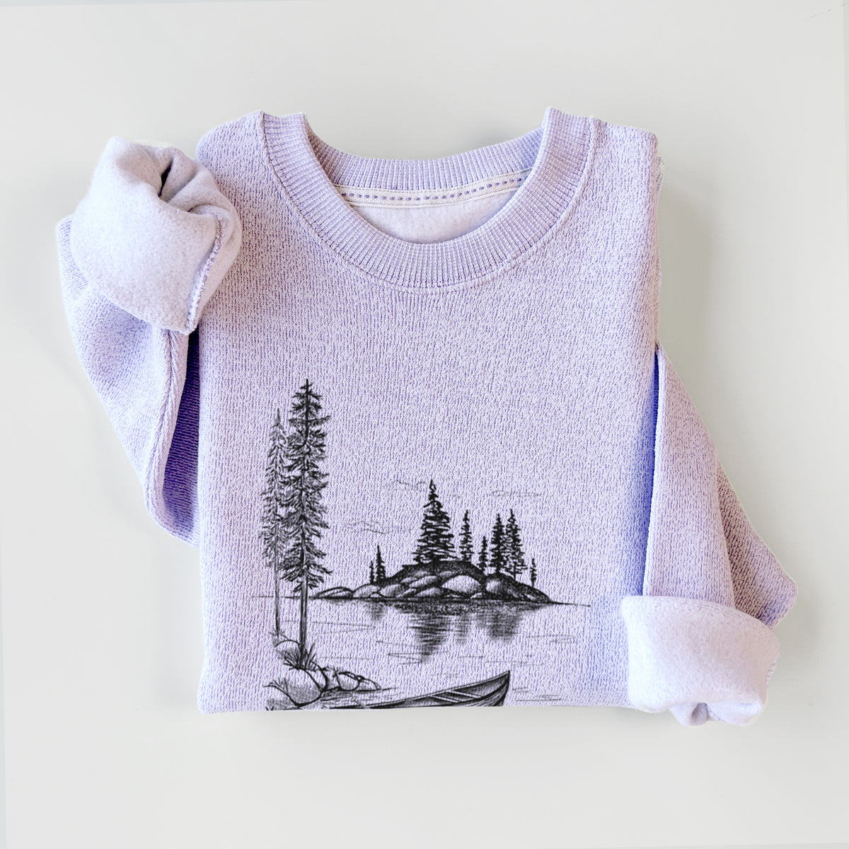 Ice purple knit sweatshirt printed with a black ink illustration of a canoe resting on the shore of a lake with pine trees on a small island, styled flat.