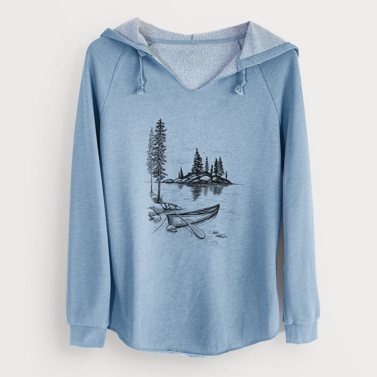 Misty blue women's Cali Wave hooded sweatshirt laid flat, printed with a black ink illustration of a canoe resting on the shore of a lake with pine trees on a small island.