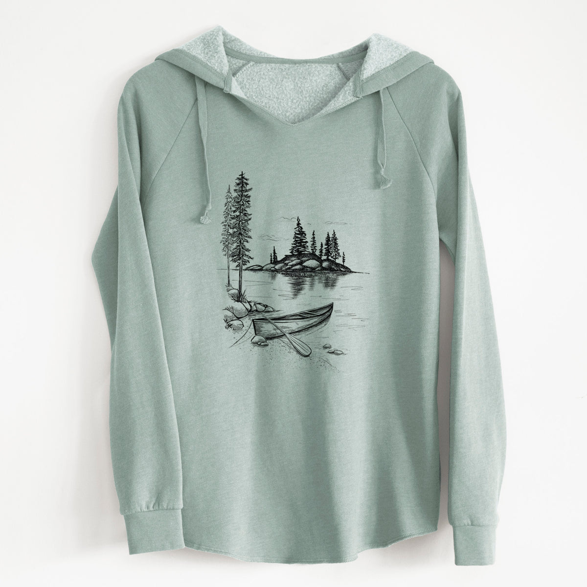 Sage green women's Cali Wave hooded sweatshirt laid flat, printed with a black ink illustration of a canoe resting on the shore of a lake with pine trees on a small island.