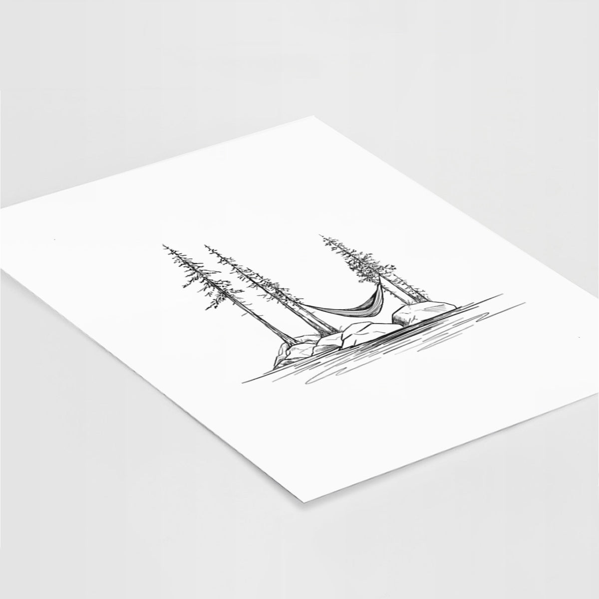 Art print of a black ink illustration of a hammock strung between pine trees on a small lakeside island, lying at an angle on a white surface.