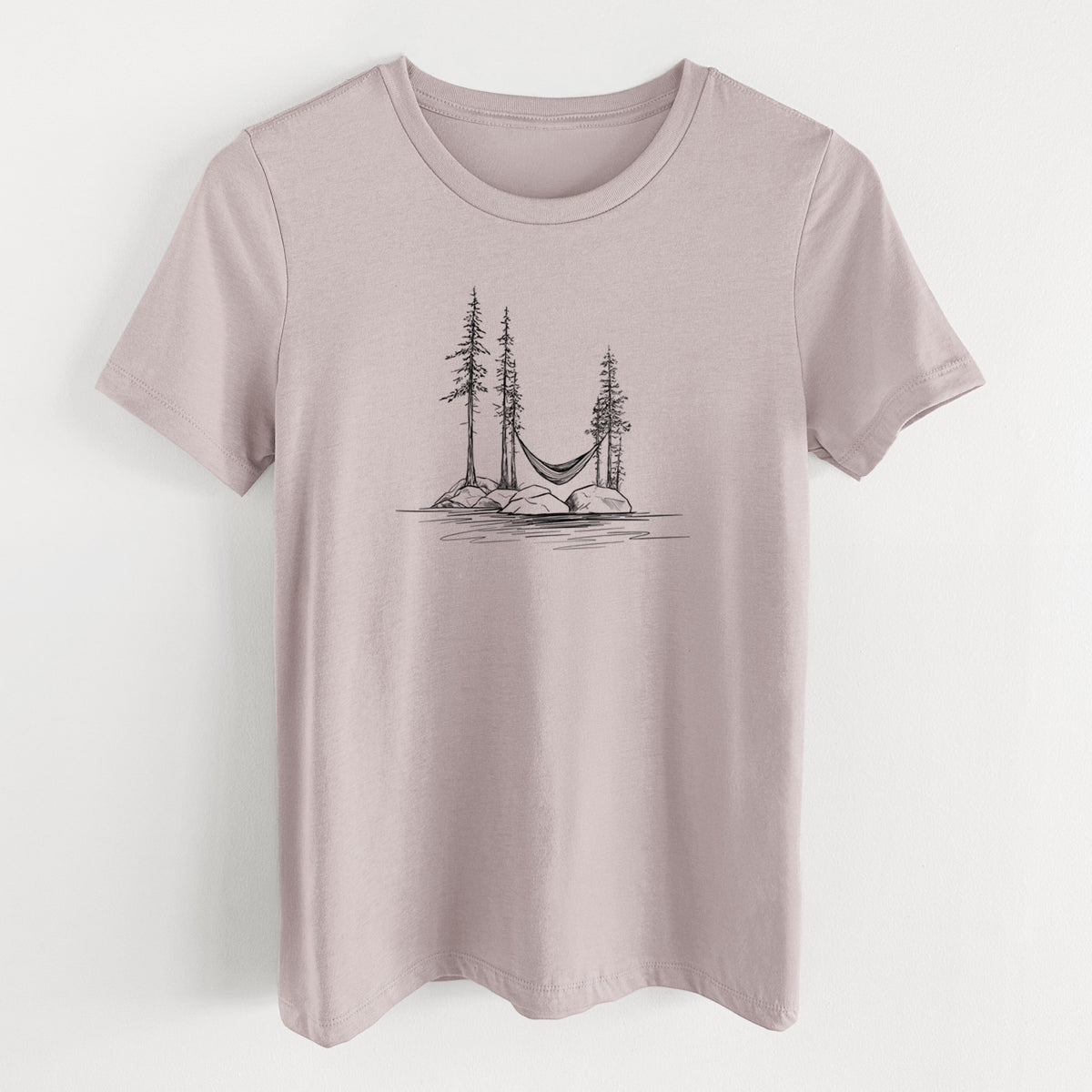 Pink gravel women's relaxed fit cotton t-shirt laid flat, printed with a black ink illustration of a hammock strung between pine trees on a small lakeside island.