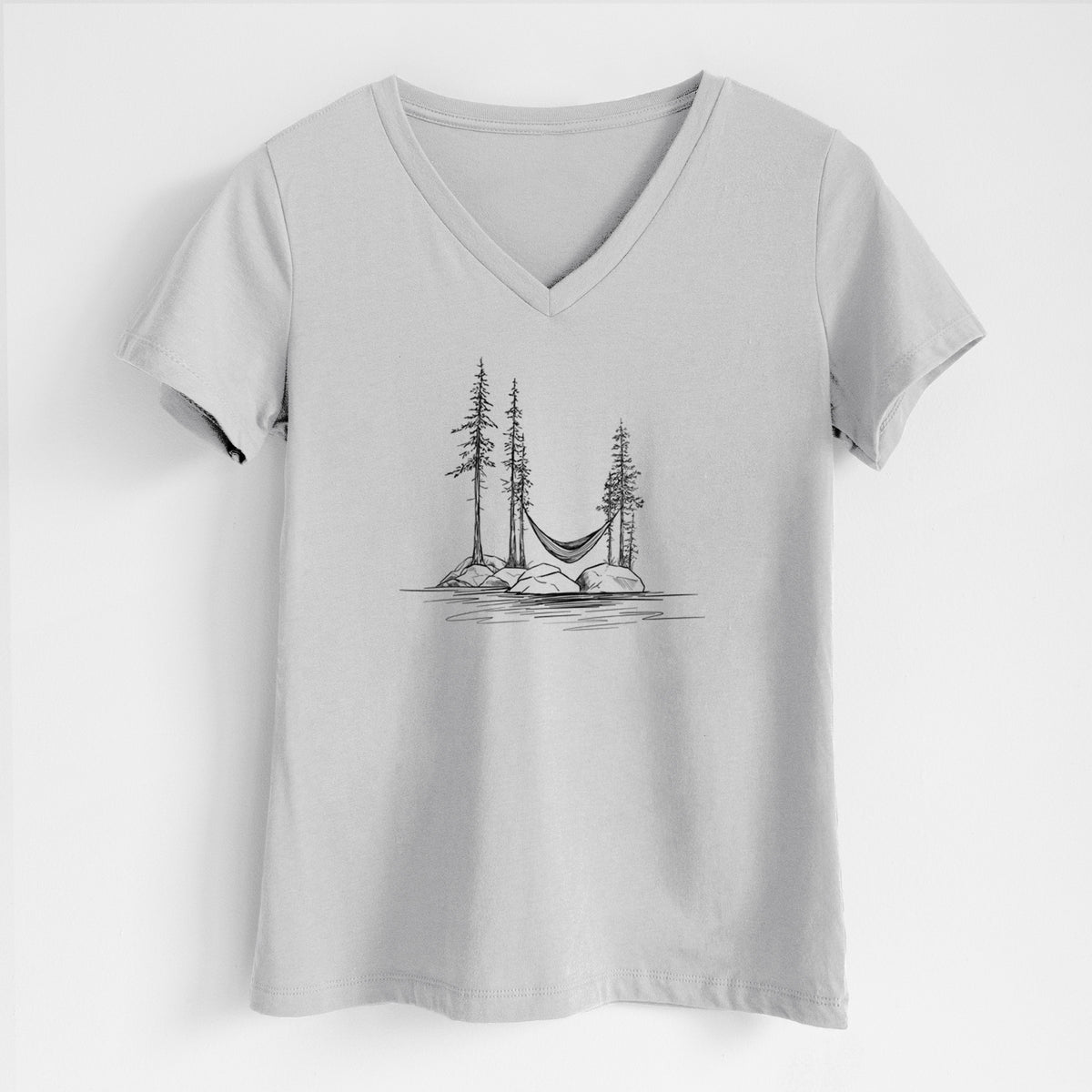 Lunar grey women's relaxed fit cotton V-neck t-shirt laid flat, printed with a black ink illustration of a hammock strung between pine trees on a small lakeside island.