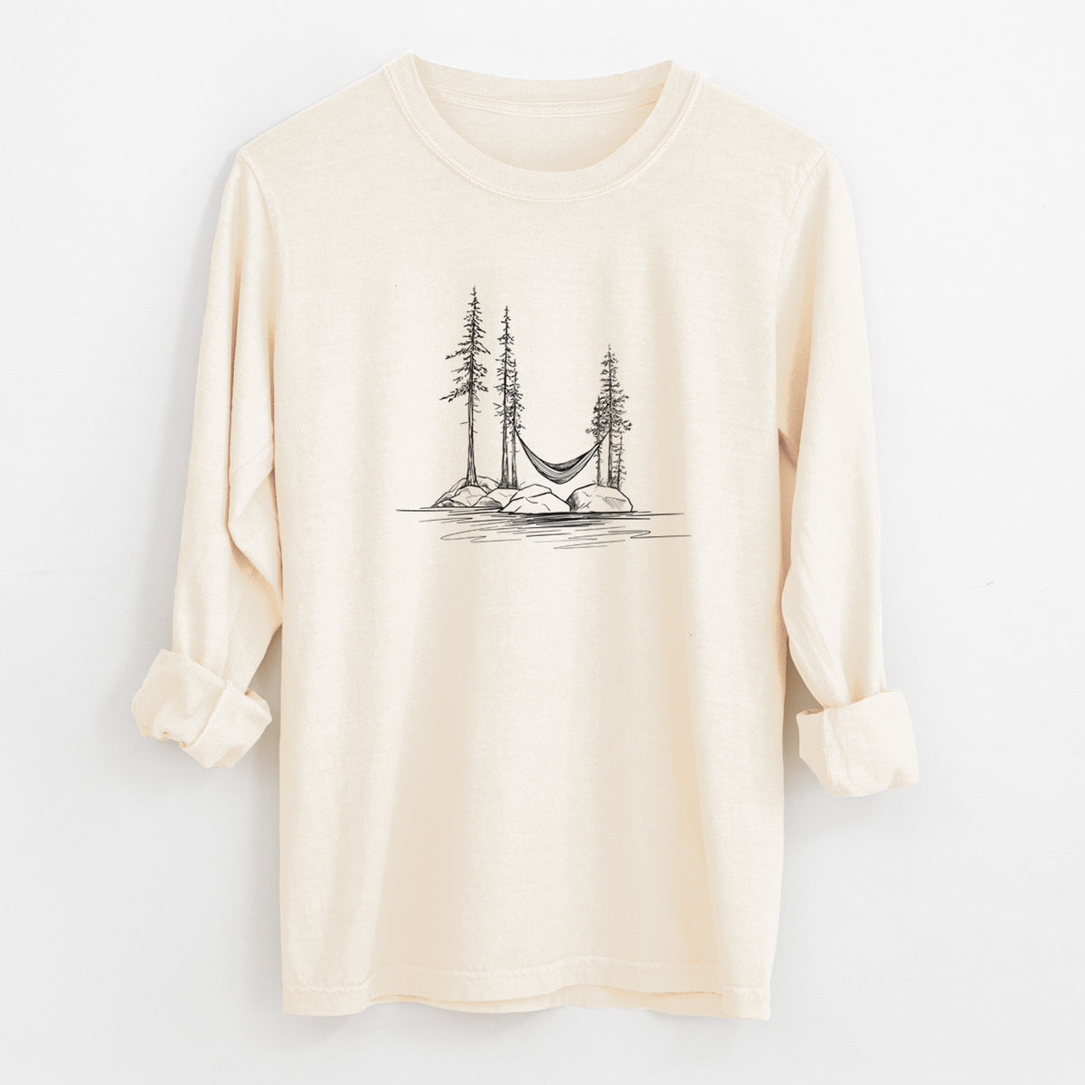 Ivory Comfort Colors long sleeve shirt laid flat with the cuffs rolled, printed with a black ink illustration of a hammock strung between pine trees on a small lakeside island.