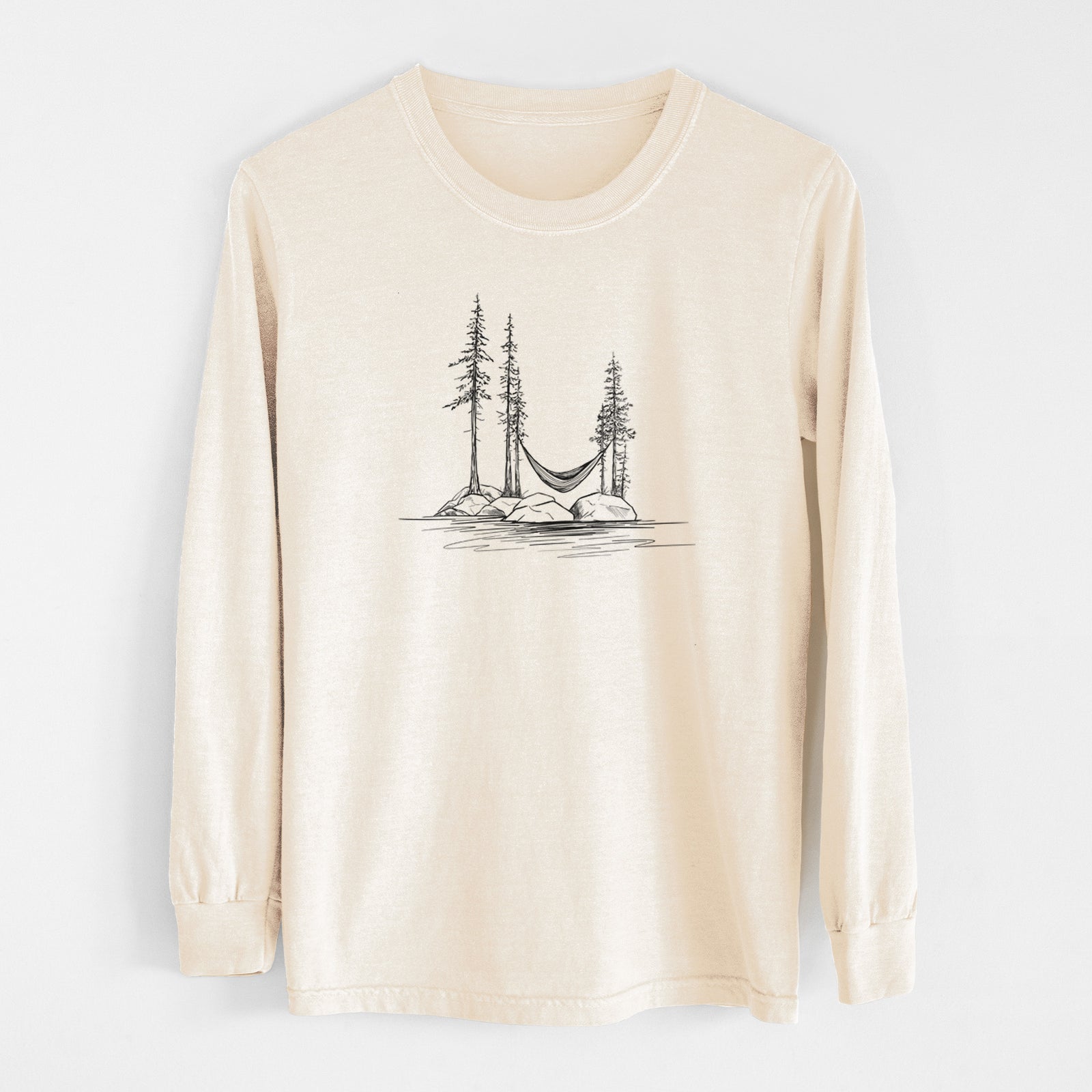 Ivory Comfort Colors long sleeve shirt laid flat, printed with a black ink illustration of a hammock strung between pine trees on a small lakeside island.