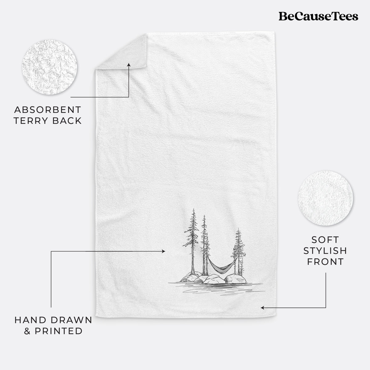 White hand towel printed with a black ink illustration of a hammock strung between pine trees on a small lakeside island.