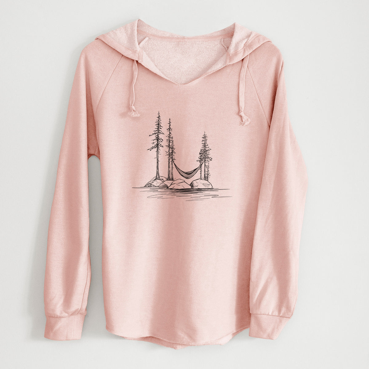 Blush pink women's Cali Wave hooded sweatshirt laid flat, printed with a black ink illustration of a hammock strung between pine trees on a small lakeside island.