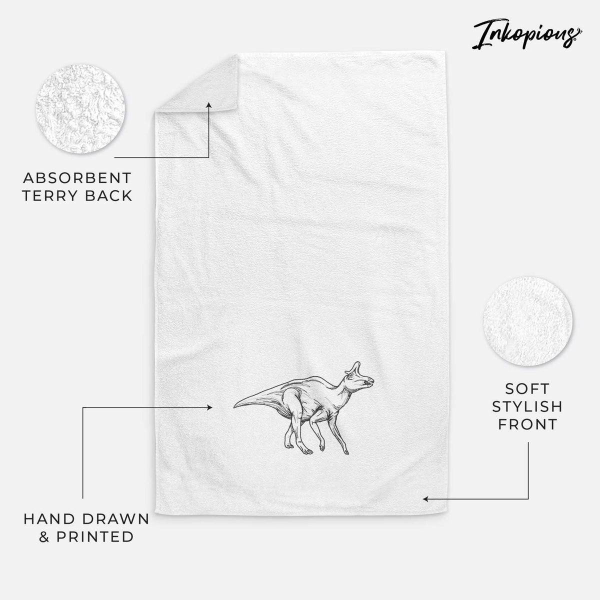 White hand towel printed with a black ink illustration of a crested Lambeosaurus walking.