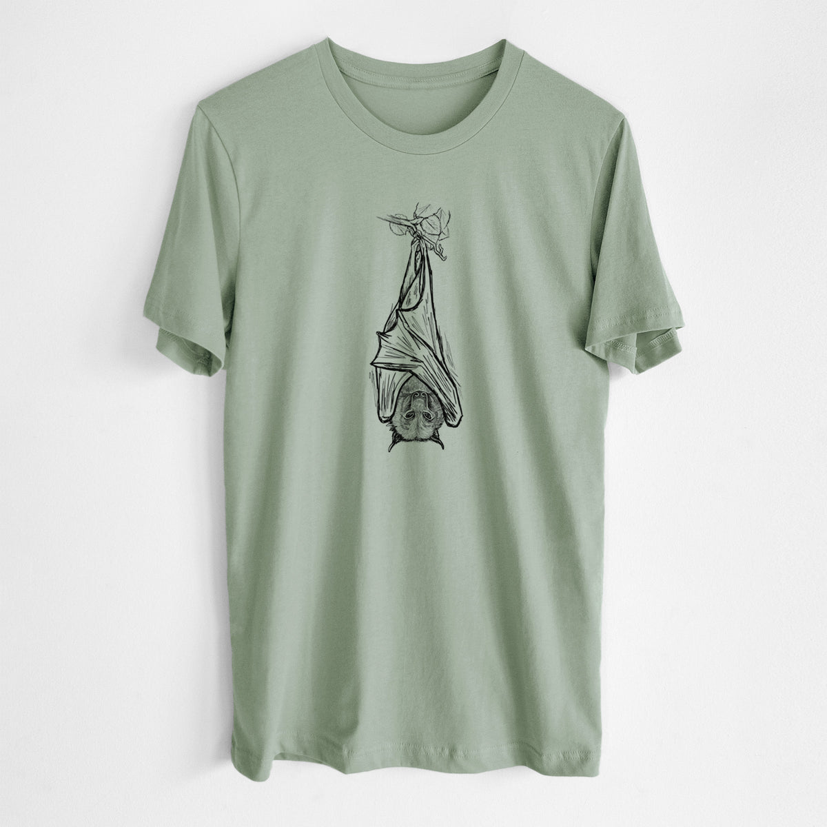 Sage green lightweight cotton t-shirt laid flat, printed with a black ink illustration of a large flying fox bat hanging upside down with its wings wrapped around it.