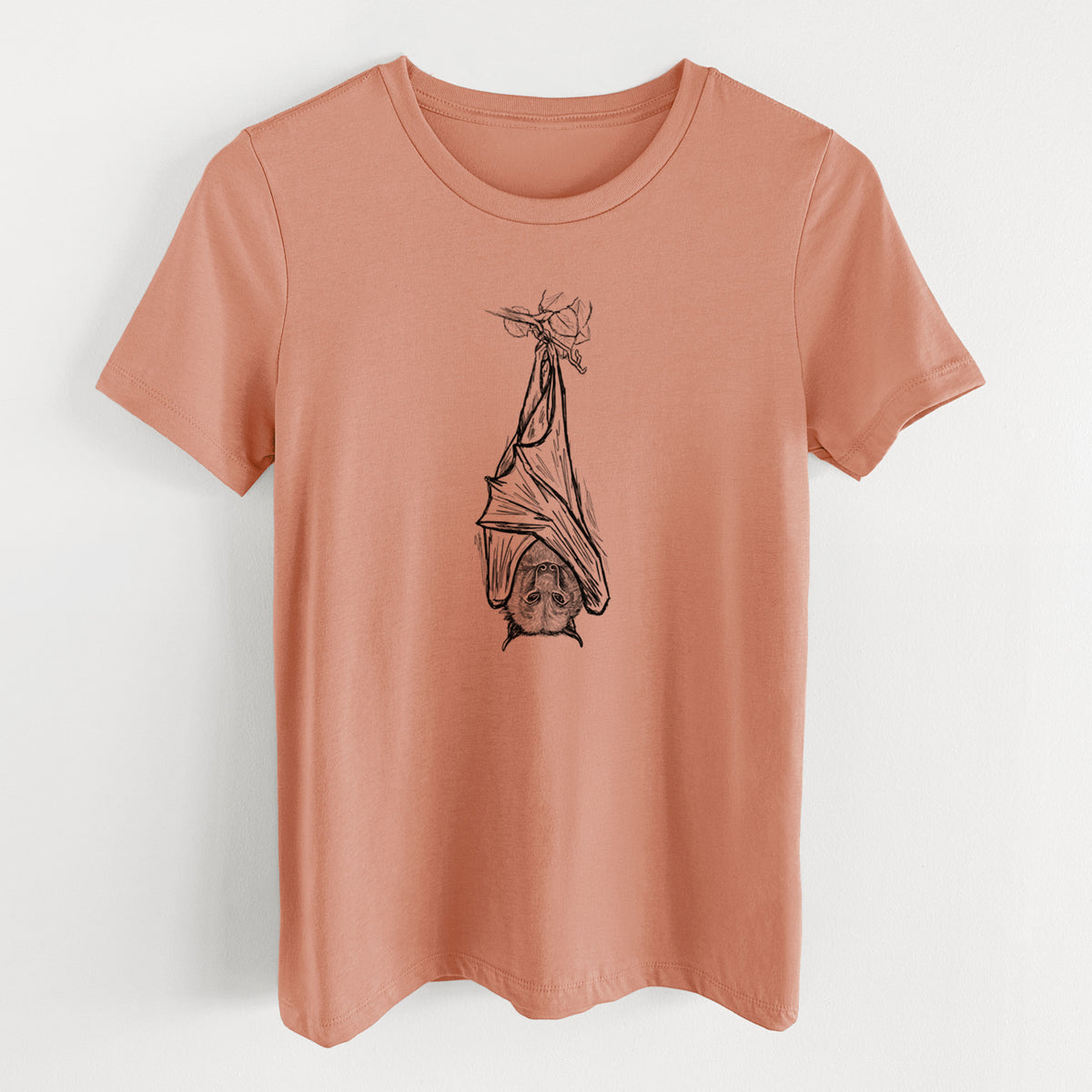 Terracotta orange women's relaxed fit cotton t-shirt laid flat, printed with a black ink illustration of a large flying fox bat hanging upside down with its wings wrapped around it.