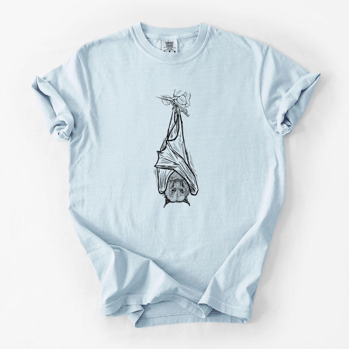Chambray blue Comfort Colors t-shirt laid flat, printed with a black ink illustration of a large flying fox bat hanging upside down with its wings wrapped around it.