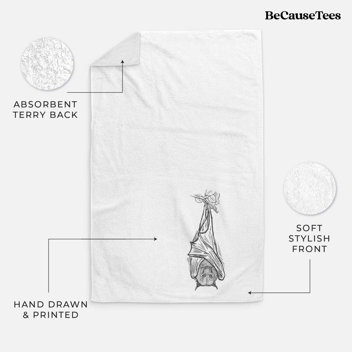 White hand towel printed with a black ink illustration of a large flying fox bat hanging upside down with its wings wrapped around it.