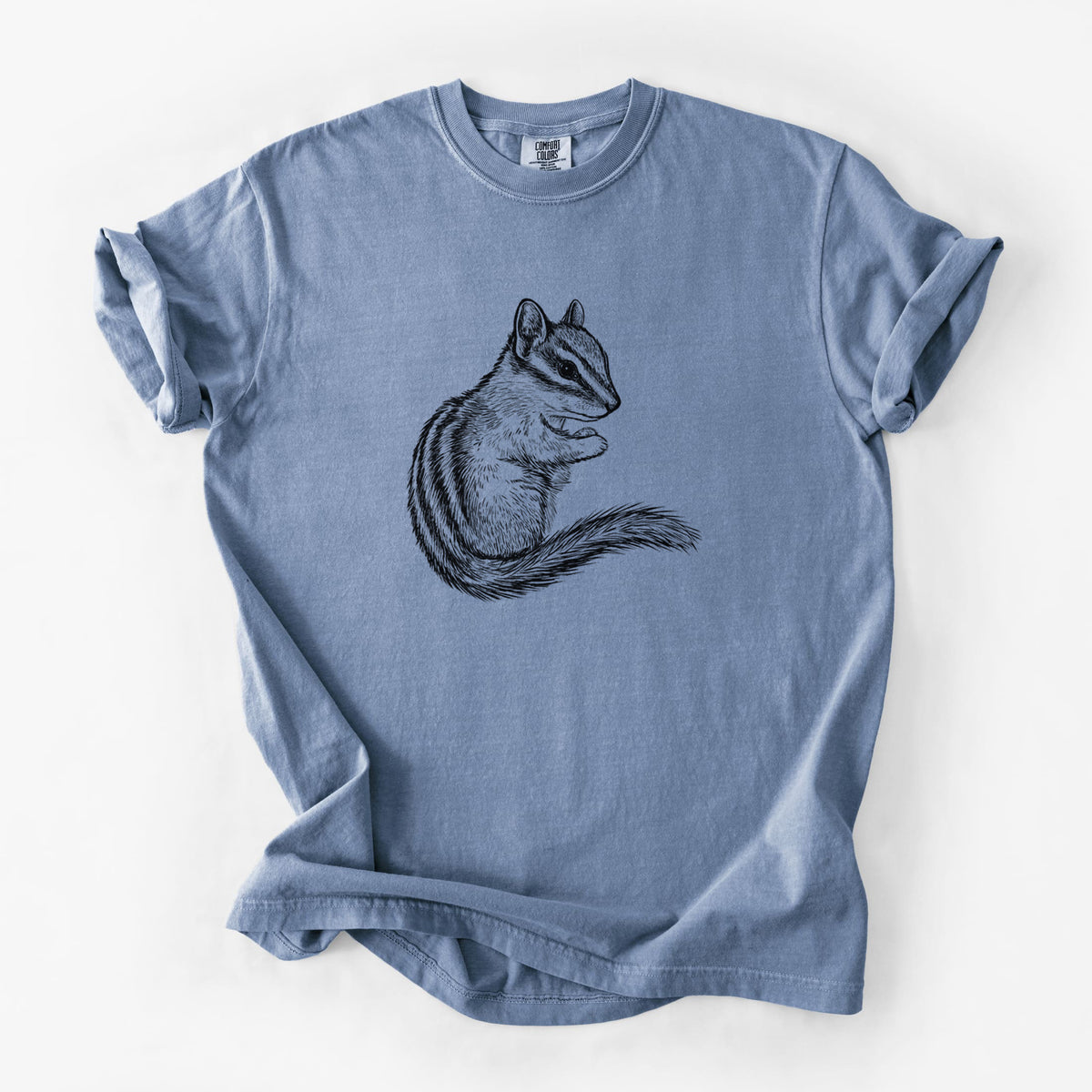 Blue jean Comfort Colors t-shirt laid flat, printed with a detailed black ink illustration of a least chipmunk sitting and holding food in its paws.