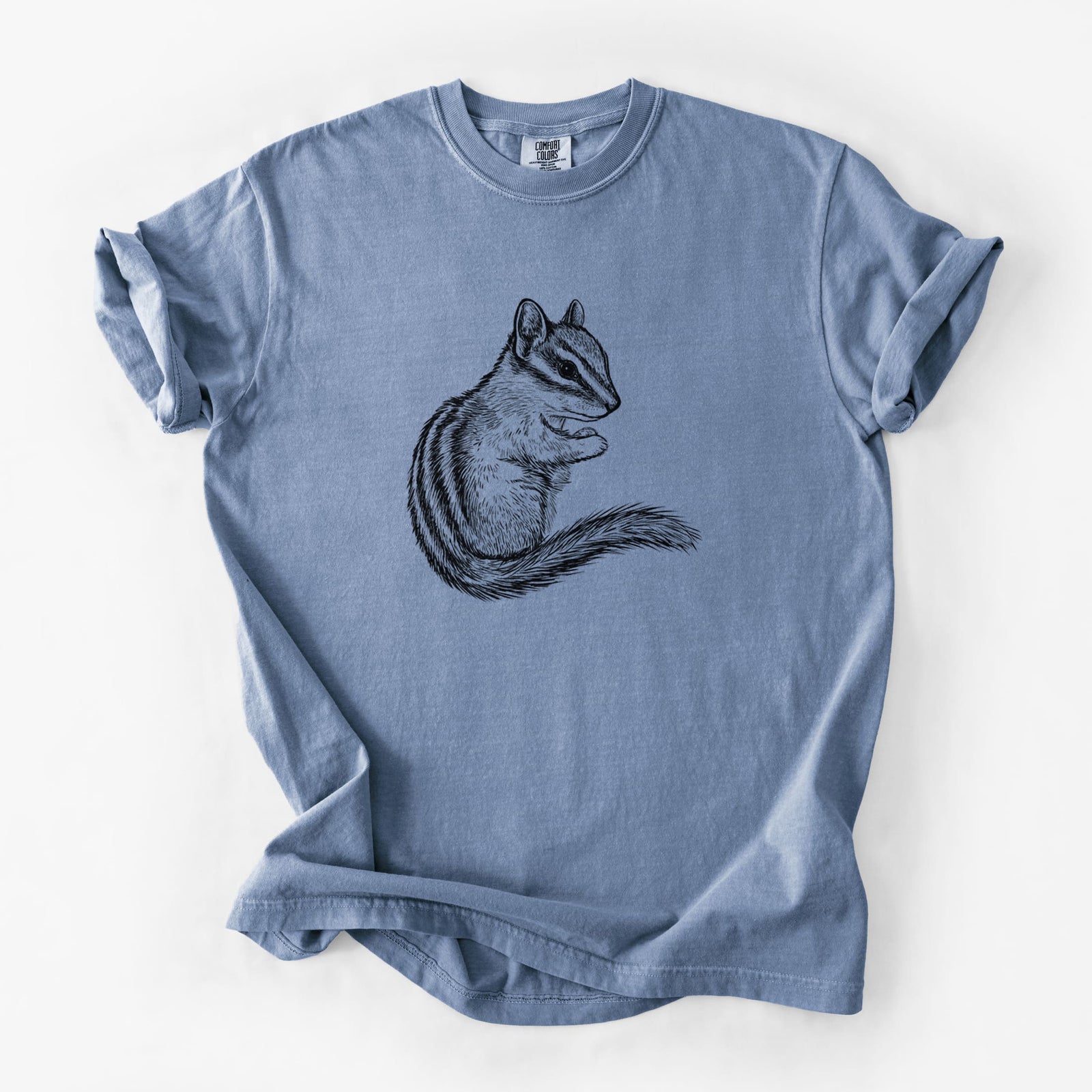 Blue jean Comfort Colors t-shirt laid flat, printed with a detailed black ink illustration of a least chipmunk sitting and holding food in its paws.