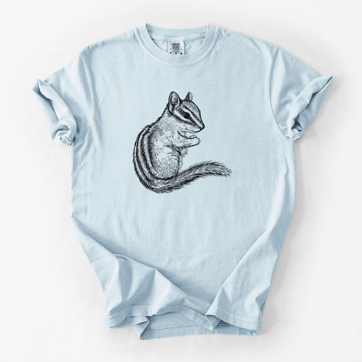 Chambray blue Comfort Colors t-shirt laid flat, printed with a detailed black ink illustration of a least chipmunk sitting and holding food in its paws.