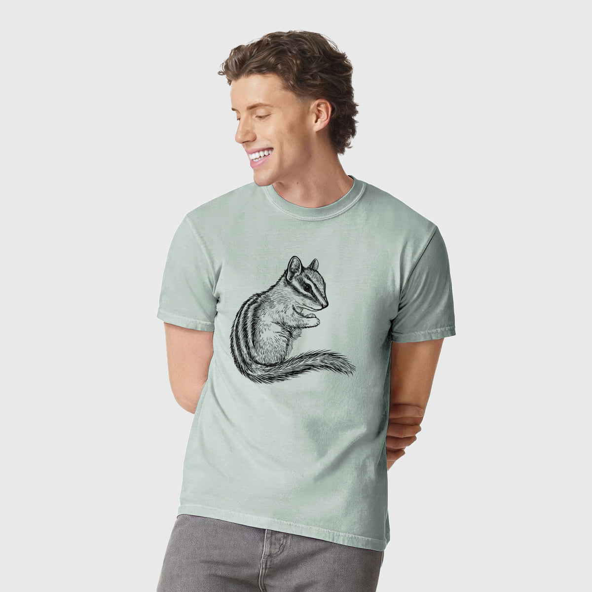 Man wearing a Comfort Colors t-shirt printed with a detailed black ink illustration of a least chipmunk sitting and holding food in its paws.