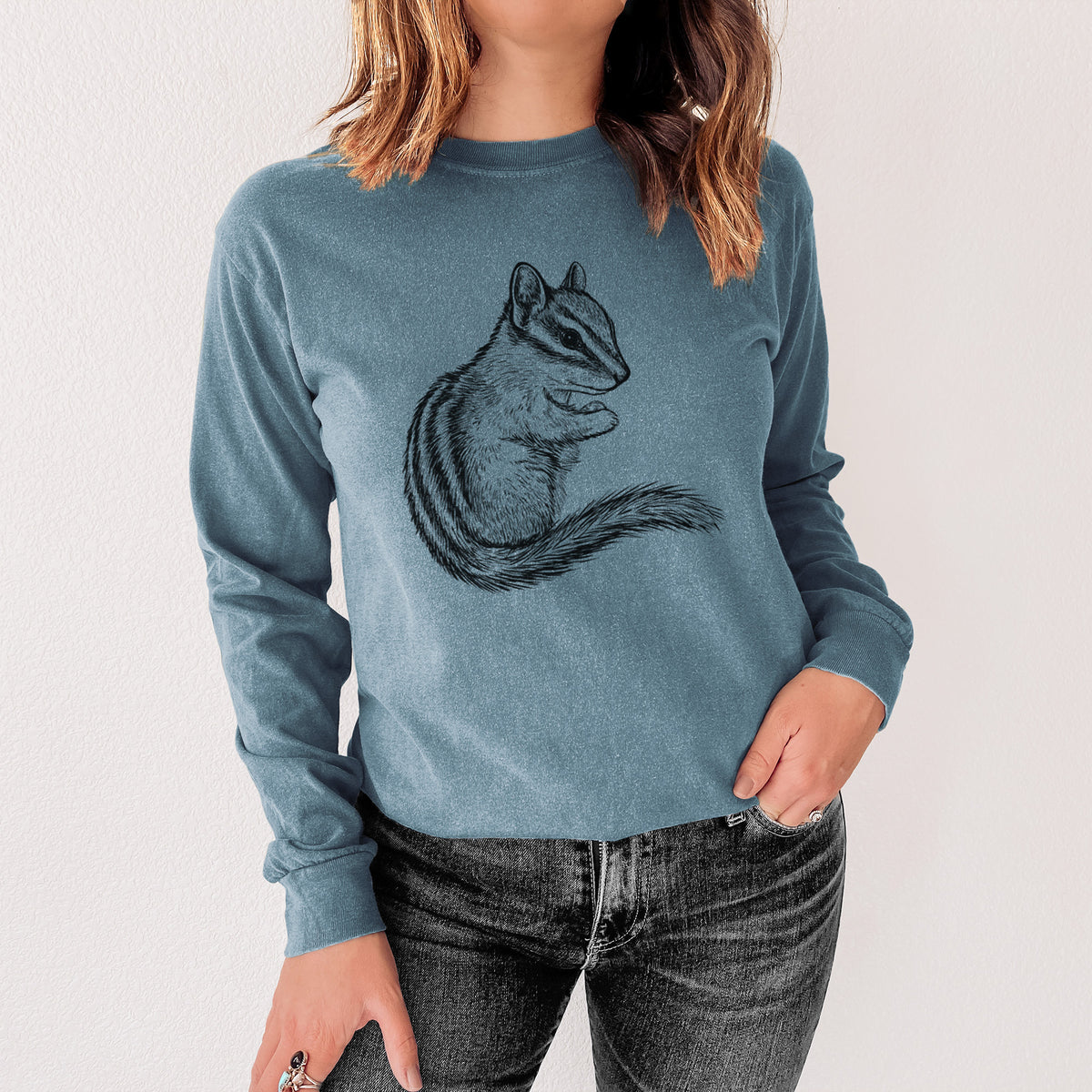 Steel blue Comfort Colors long sleeve shirt printed with a detailed black ink illustration of a least chipmunk sitting and holding food in its paws, shown in a lifestyle photo.