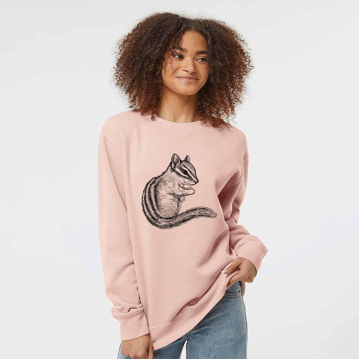 Model wearing a dusty pink pigment dyed crewneck sweatshirt printed with a detailed black ink illustration of a least chipmunk sitting and holding food in its paws.