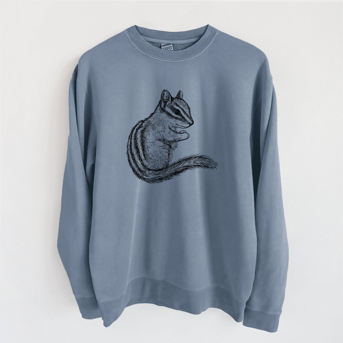 Slate blue pigment dyed crewneck sweatshirt laid flat, printed with a detailed black ink illustration of a least chipmunk sitting and holding food in its paws.
