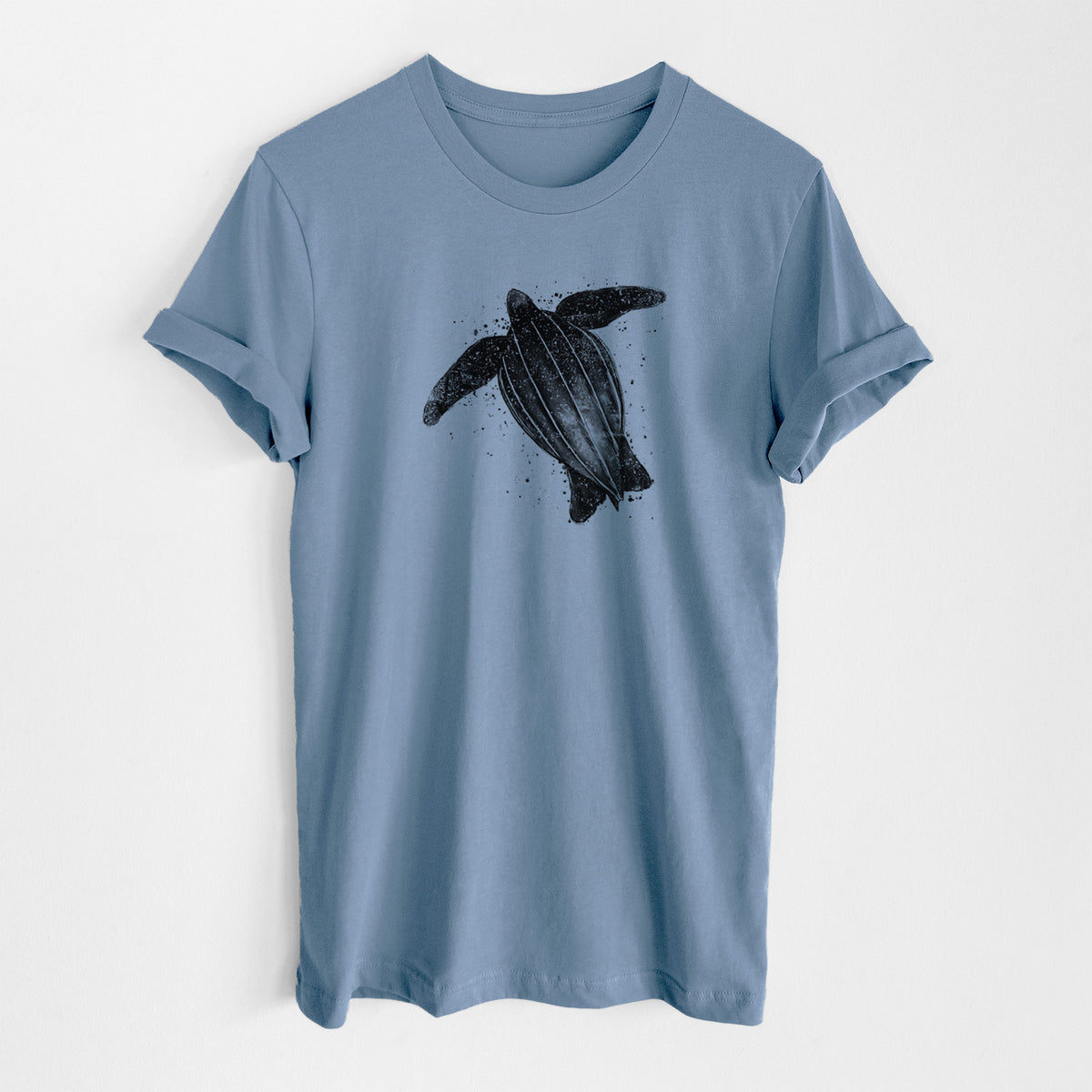 Steel blue lightweight cotton t-shirt laid flat, printed with a black ink illustration of a leatherback sea turtle swimming, with ink splatters.