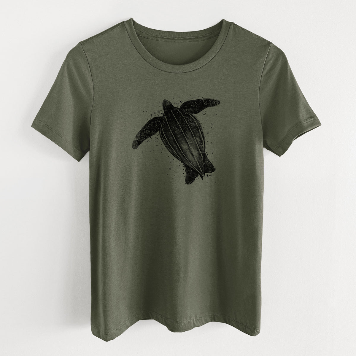 Military green women's relaxed fit cotton t-shirt laid flat, printed with a black ink illustration of a leatherback sea turtle swimming, with ink splatters.