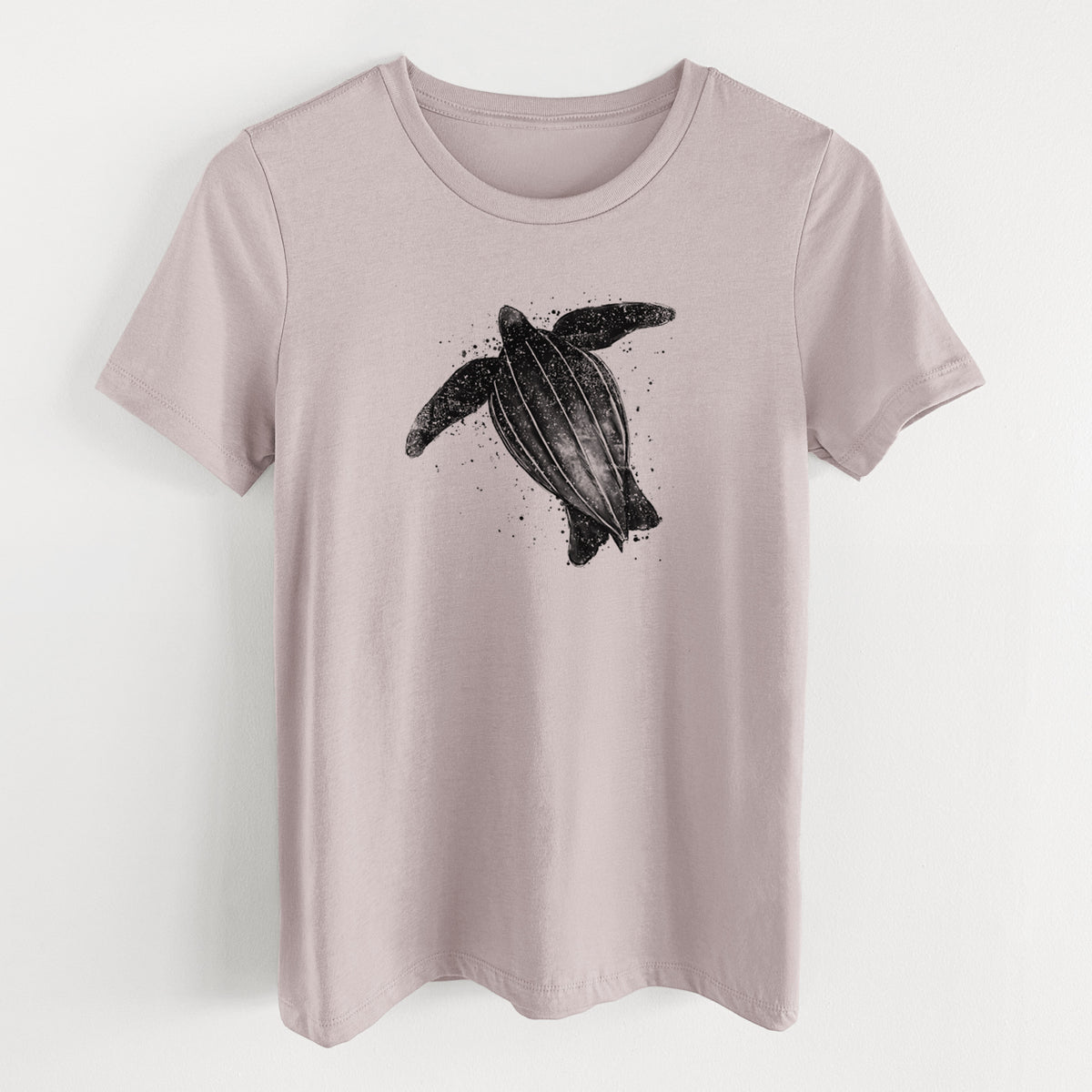 Pink gravel women's relaxed fit cotton t-shirt laid flat, printed with a black ink illustration of a leatherback sea turtle swimming, with ink splatters.