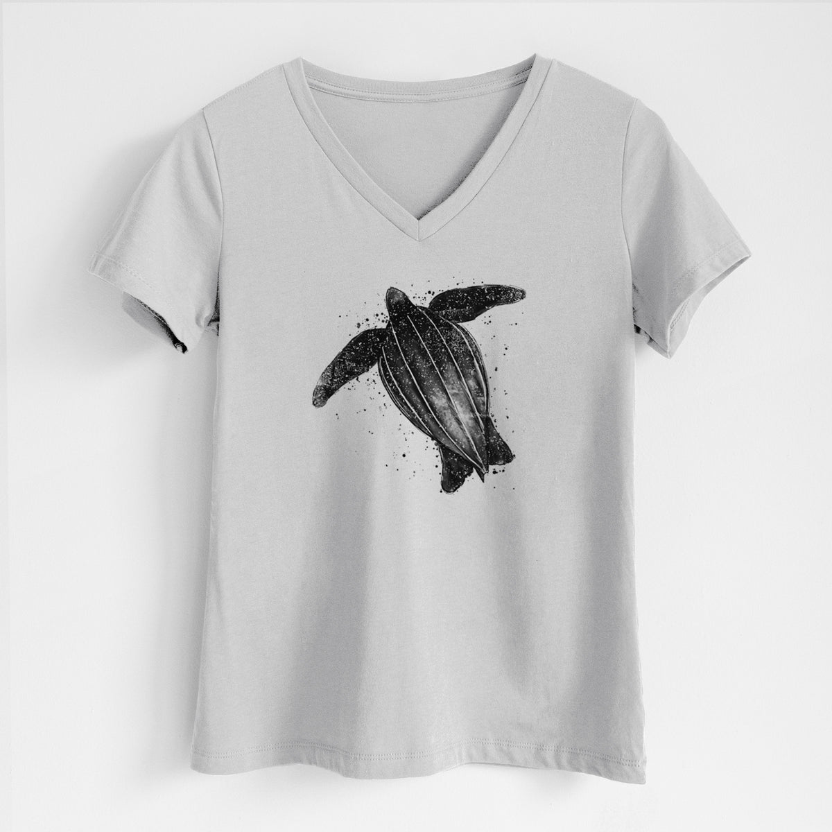 Lunar grey women's relaxed fit cotton V-neck t-shirt laid flat, printed with a black ink illustration of a leatherback sea turtle swimming, with ink splatters.